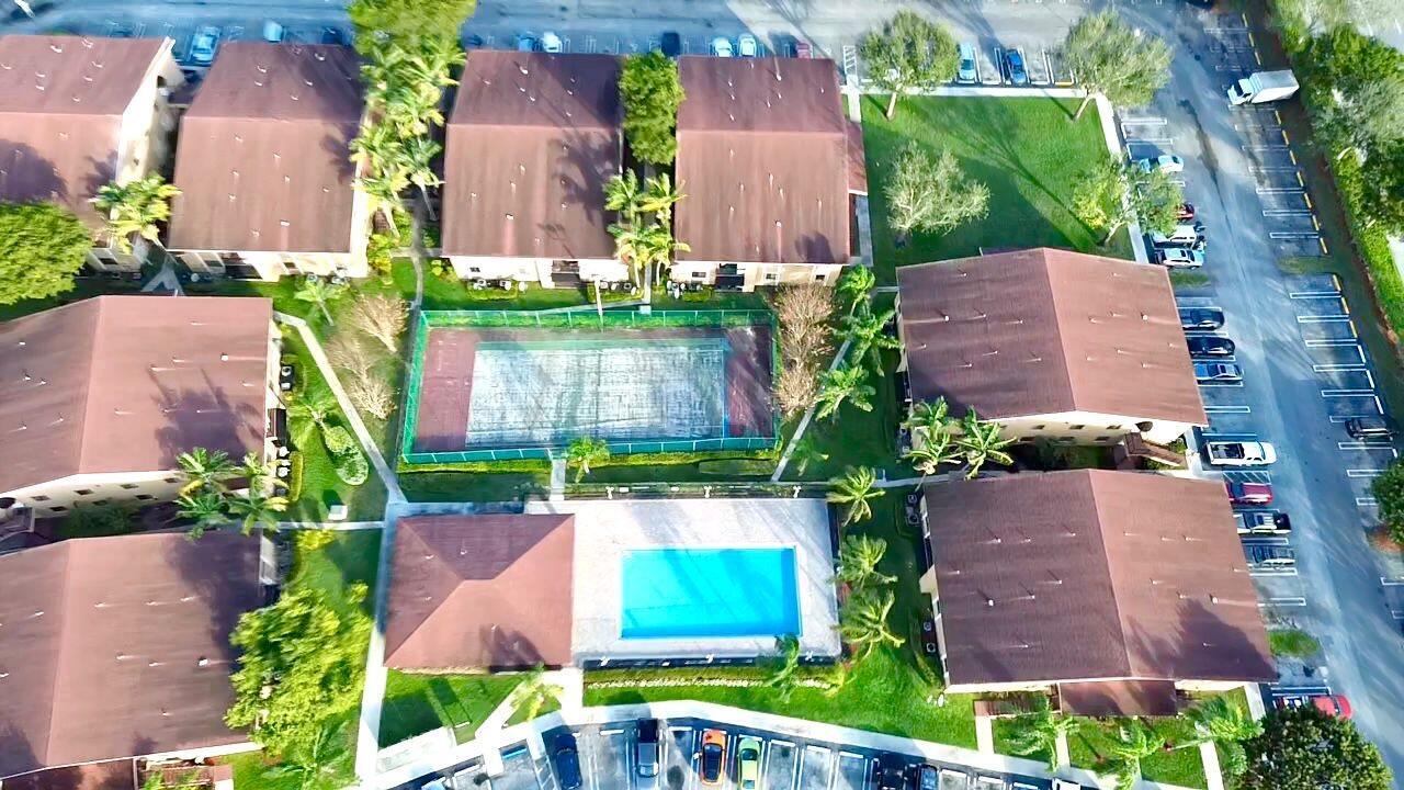 Attention Investors! Spacious 2-bedroom, 2-bathroom first-floor condo with tile flooring throughout. Enjoy serene pool views from the covered balcony. The unit includes washer and dryer, and there are no rental restrictions, making it a fantastic investment opportunity. Currently rented to exceptional tenants $ 1,950 until 11/30/26 Located in a family-friendly, quiet community featuring amenities such as a pool and tennis court. Centrally located with low HOA fees. Suitable for all ages. Don't miss out !