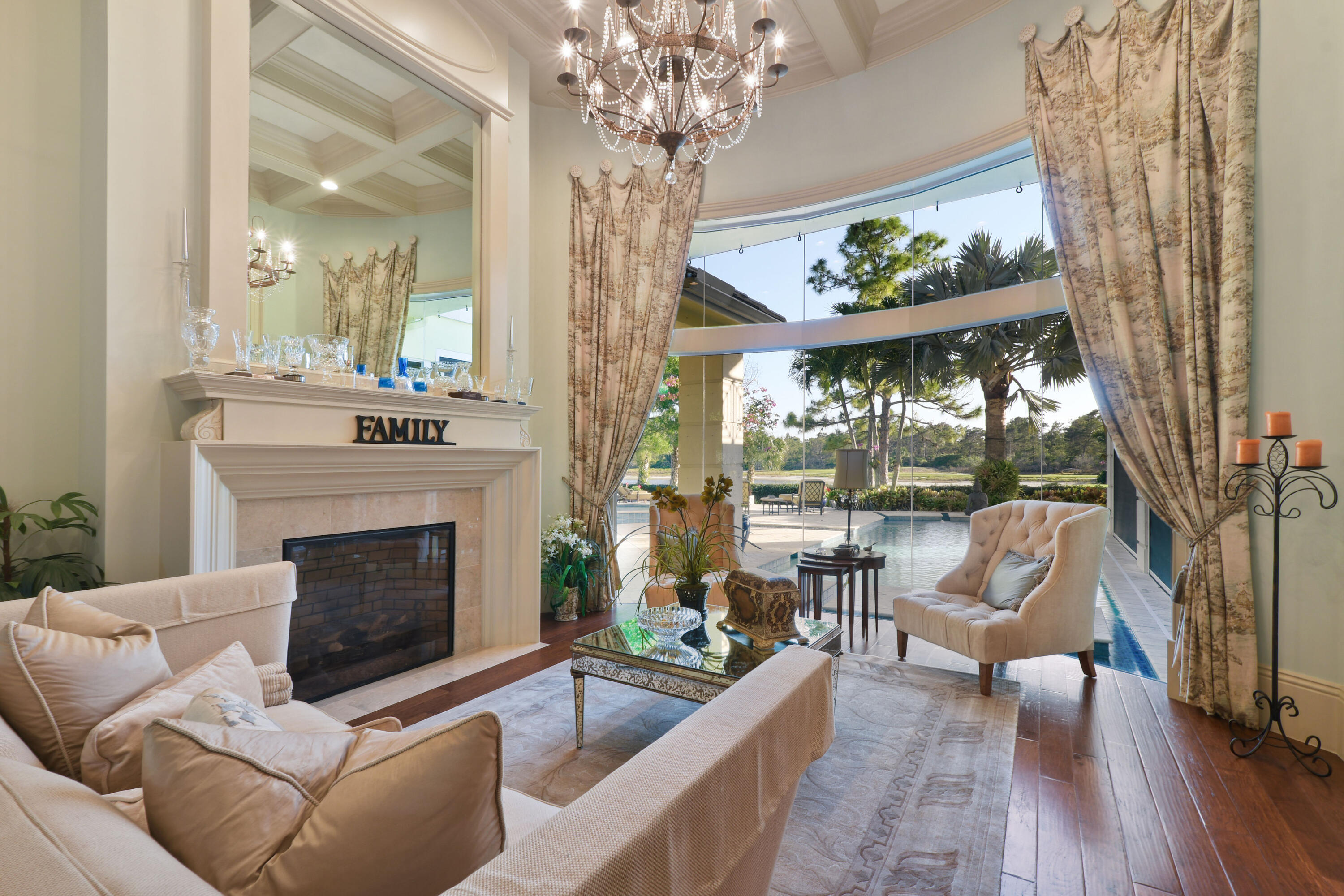 As one enters this home through double mahogany doors your eyes are immediately drawn to the volume ceilings & walls of glass overlooking the pool, yard, golf course, lake & nature preserve. Situated on a private 1/2 acre lot boasting 5 bedrooms, 6 full bathrooms, 2 powder rooms, along with a Movie Theater, Game Room with wet bar, summer kitchen, sculpture garden, 2 story closet in primary, 2 laundry rooms, elevator, multiple bars, fireplace, office & 5 car garage! Marble pavers in the front and back of the estate set the stage for a presence of luxury. High and dry, elevated pad for dramatic views. This home has the perfect floor plan for entertaining.  Medalist Village has a 12 hole Greg Norman Par 3 golf course, restaurant, spa, tennis & gym.  Sellers rep is tenant