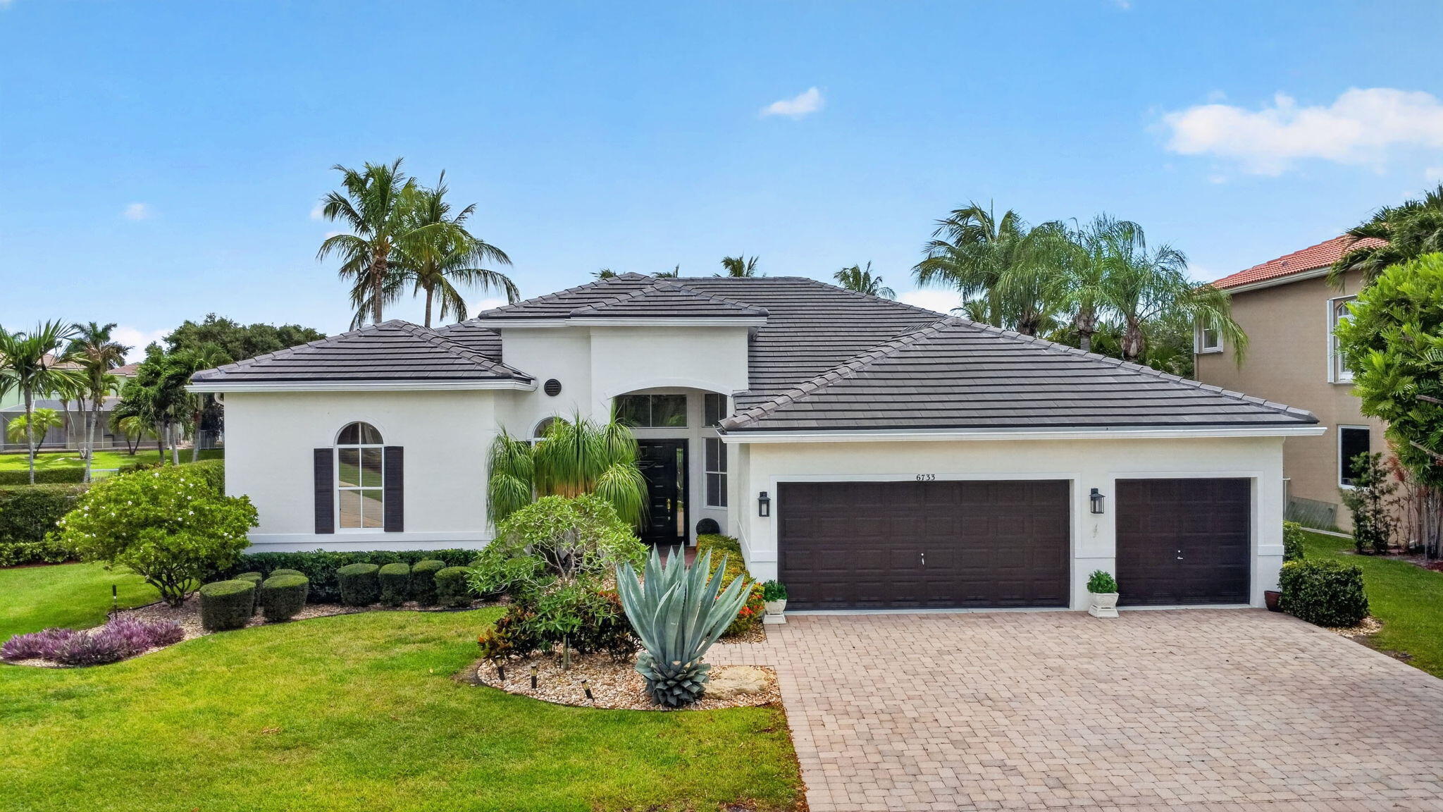 Welcome to your lakefront paradise in highly sought-after Journeys End! This spectacular single-story home features 5 bedrooms in a 3-way split, 3 full baths, a 3-car garage, full hurricane protection, and a new 2023 roof. The chef's kitchen is enhanced with granite countertops and stainless steel appliances, breakfast area, and opens to large family room. Step into your huge primary suite with a versatile sitting area perfect for a home office or gym. Step outside to your private oasis featuring sweeping lake views, a pristine pool & spa, and an extensive paver patio. Located in west Lake Worth, this vibrant, pet-friendly community is zoned for top-tier A-schools and sits near shopping, dining, and major highways and less than 15 mins from sandy beaches. This home truly checks every box!