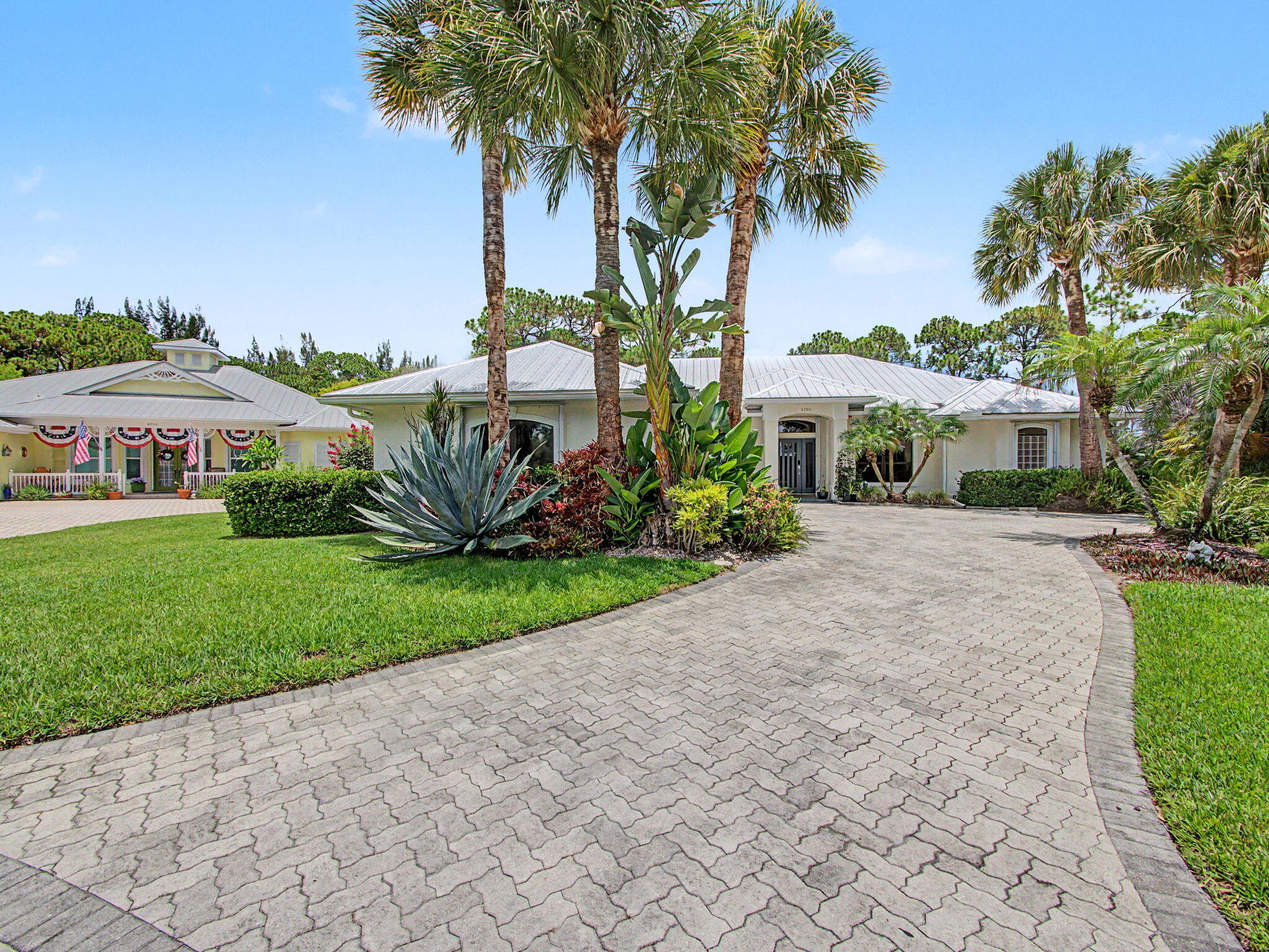 Welcome to this beautifully updated 4-bedroom, 2.5-bath pool home, perfectly positioned on a quiet cul-de-sac in the highly sought-after gated community of Locks Landing.  From the moment you enter through the new striking modern impact-rated front door, you'll appreciate the spacious layout featuring a formal living room and formal dining room, ideal for entertaining, along with a large family room that opens seamlessly to the kitchen and breakfast room. The updated kitchen is the heart of the home, showcasing granite countertops, abundant cabinetry, and new 2024 appliances.  The spacious primary suite provides a relaxing retreat with direct access to the lanai and features a beautifully remodeled spa-inspired bathroom complete with a large walk-in shower with frameless glass enclosure, a luxurious soaking tub, modern double vanity, elegant new tile flooring, and designer finishes throughout. Step outside to your own private backyard oasis where a recently resurfaced screened pool and spa overlook a tranquil preserve, creating the perfect setting for relaxing or entertaining year-round. The expansive screened lanai offers plenty of room to enjoy Florida's outdoor lifestyle while surrounded by the privacy and natural beauty of the preserve. Additional updates include a 2020 metal roof, 2023 air conditioning system, and a 2024 water heater, providing years of worry-free ownership. Locks Landing is one of Martin County's premier gated waterfront communities, offering 60 privately deeded ocean-access boat slips, a private boat ramp, and secure boat/trailer storage. Conveniently located near shopping, dining, top-rated schools, beaches, and major highways, this exceptional home offers the perfect combination of luxury, privacy, and an active Florida