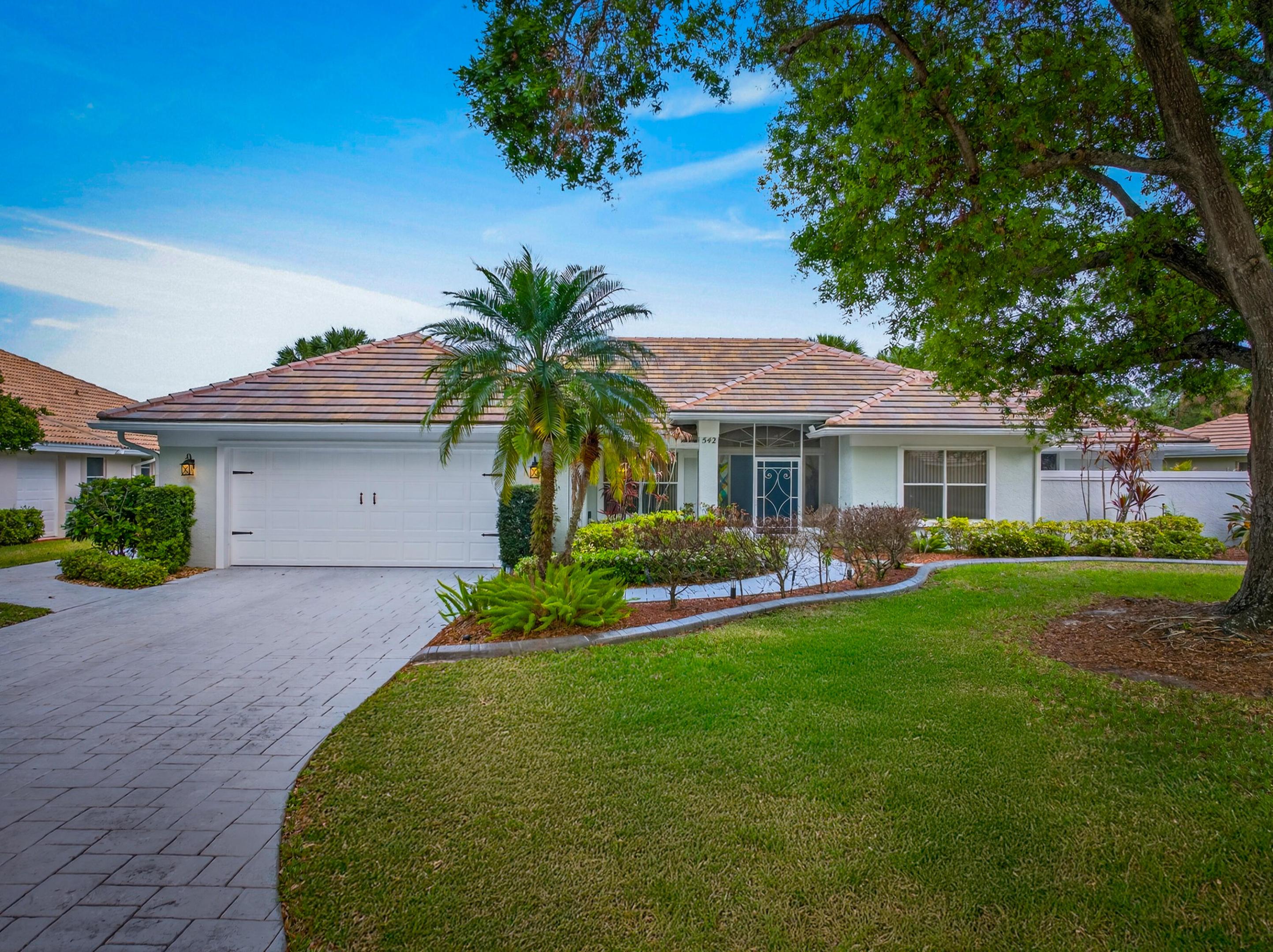 Brand NEW concrete slate tile roof (2024) sets the tone for this beautifully maintained home in The Sanctuary, offering LAKE AND GOLF COURSE VIEWS on a private 0.27-acre lot. This 3 bedroom, 2.5 bath, and 2,338 living sq ft, home features vaulted ceilings, wood-look flooring, formal dining, and a convenient wet bar. The remodeled kitchen includes stainless steel appliances, gas cook-top, wall oven, island, and plenty of cabinet space. Enjoy a resurfaced gas-heated pool with screened patio and access from both the primary and guest bedrooms. Additional highlights include accordion shutters, EV charger (in garage), 2.5-car garage (including golf cart bay), new gas water heater, and lush landscaping. Luxury, comfort, and location all in one!