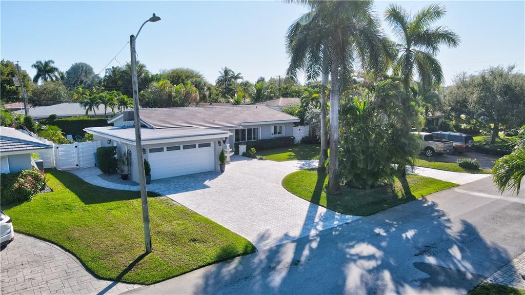 Amazing opportunity awaits in Coral Heights! This 3BR2BA split floor plan offers an enormous living area and large screen room that brings the outside in! What's new? The concrete tile roof! The AC! All new permitted 2 car garage and huge circular paved driveway, impact windows/doors and new water heater! This one also offers a large updated kitchen with gorgeous granite, gas cooking, and Kitchen Aid wall oven.  Tile flooring is throughout the home and all 3 bedrooms are a great size! Interior laundry room would make a great office and has TONS of storage. Outdoors you find a beautifully fenced yard with attractive pool and deck, an attractive landscape, and a sizeable green space with storage shed. Lovingly cared for, all you have to do is furnish this one to make it your own!
