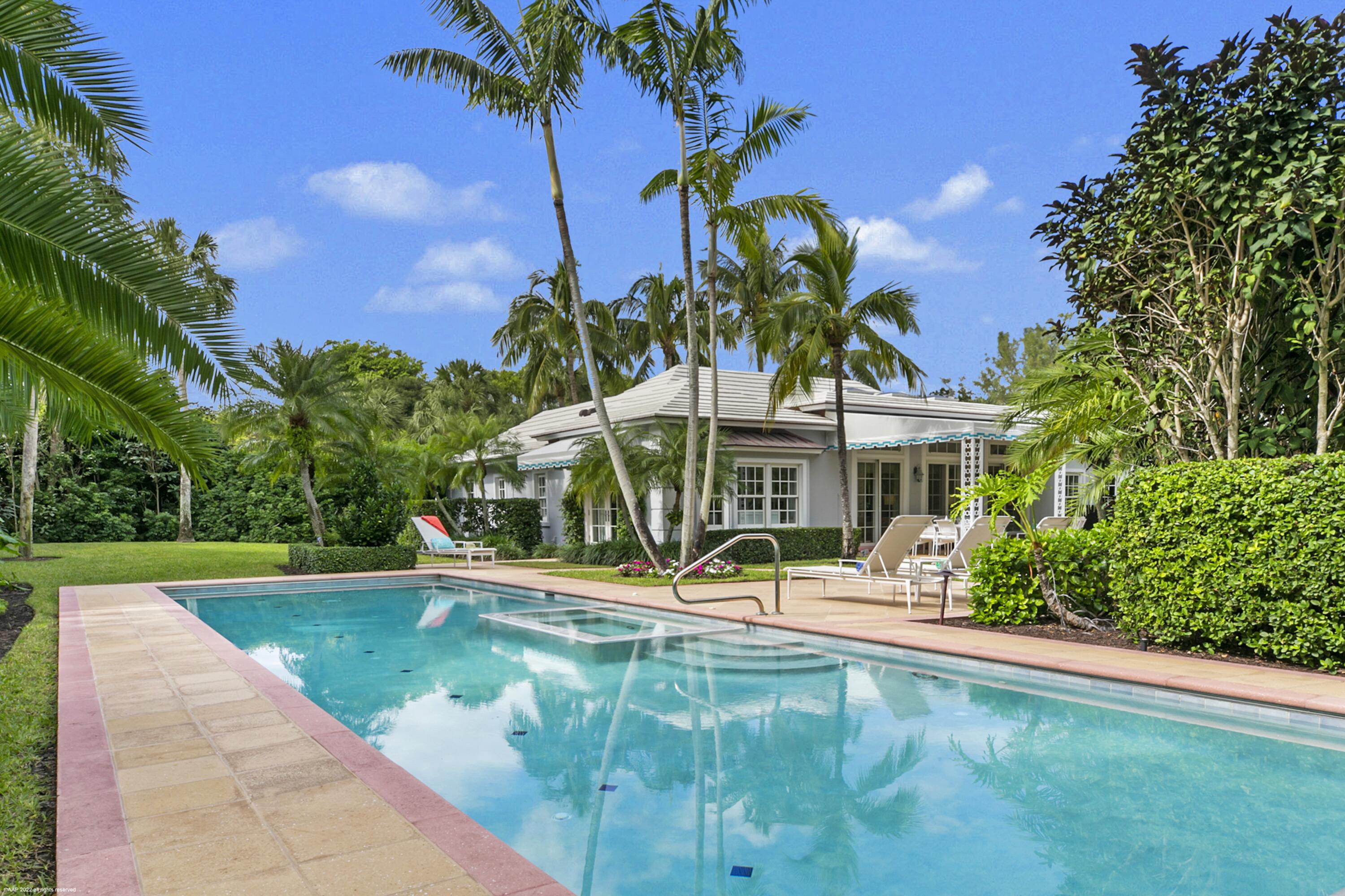 Nestled within a lush setting, just a short walk to beautiful beaches, this impeccably maintained and recently updated Bermuda style residence offers 4,600 +/- of luxurious comfort. Family and guests will enjoy the privacy of the 2-story guest wing. The main living areas include formal living room and dining rooms, a fully remodeled kitchen, family room, a sun-filled entertaining room and a master suite with adjoining  office (6th BR). The outdoor areas feature an expansive covered patio overlooking the verdant backyard offering a pool, spa and fountain amid fruit trees and a recently refurbished landscape.  Roof and skylights replaced in 2020. New impact garage doors 2021. Kemble  Interiors in 2020: carpet, paint, wallpaper,  furnishings, draperies and guest wing shutters. New shutters in guest wing 2020, new patio furniture 2020, new pool heater 2020, new Aurora landscape lighting 2021, new guest wing a/c 2021, 1st floor guest bath remodeled 2021, new lift and slide patio doors in loggia and French doors in primary bedroom 2022, new driveway drainage system 2022, new awning 2021. This home is offered fully furnished decorated by Kemble Interior Design in 2020 !