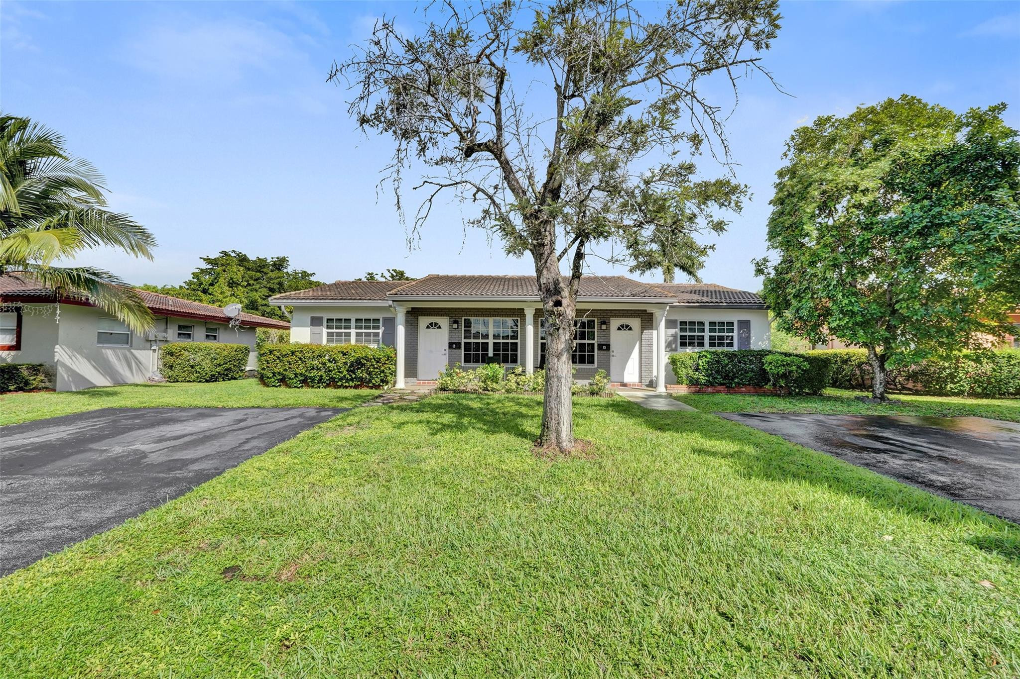 Turnkey duplex investment in Coral Springs showing two renovated 2 bed 2 bath units with fresh flooring, upgraded lighting, and modern kitchens with new appliances. Each side includes washer and dryer, private entrances, and impact windows. The exterior features updated landscaping, a spacious fenced yard, and relaxing canal views. Parking for several cars. Well maintained with strong rental demand, with room to improve returns through market adjustments.