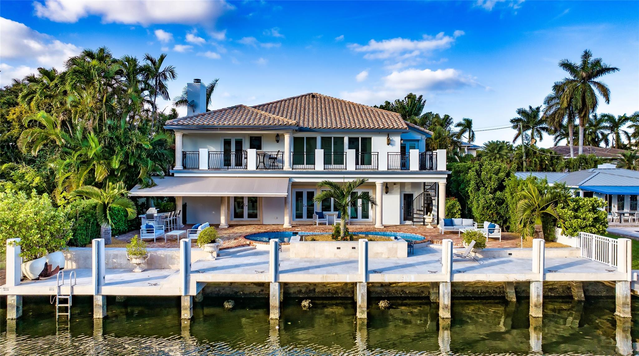 Surrounded by lush landscaping, this reimagined private gated residence, with a Chicago-brick motor-court entry, offers a majestic sense of arrival. The loggia & second-floor balcony overlook 75' of water-frontage, heated pool, and new summer kitchen with a retractable awning. Inside, this 4 bedroom plus den/office European-inspired gem, with 4,689 sq ft, features rich maple and granite-slab flooring, custom molding, architectural columns & archways, hurricane-rated windows/doors, and a newer roof. Formal rooms downstairs include a dining room, breakfast room, wine cellar, office, game room, guest-bedroom, powder room, extra laundry room, and a cabana bath with storage. The master suite offers water views, a huge walk-in wardrobe, & a double vanity bath with soaking tub & walk-in shower. DISCLAIMER: Information published or otherwise provided by the listing company and its representatives including but not limited to prices, measurements, square footages, lot sizes, calculations, statistics, and videos are deemed reliable but are not guaranteed and are subject to errors, omissions or changes without notice. All such information should be independently verified by any prospective purchaser or seller. Parties should perform their own due diligence to verify such information prior to a sale or listing. Listing company expressly disclaims any warranty or representation regarding such information. Prices published are either list price, sold price, and/or last asking price. The listing company participates in the Multiple Listing Service and IDX. The properties published as listed and sold are not necessarily exclusive to listing company and may be listed or have sold with other members of the Multiple Listing Service. Transactions where listing company represented both buyers and sellers are calculated as two sales. The listing company’s marketplace is all of the following: Vero Beach, Town of Orchid, Indian River Shores, Town of Palm Beach, West Palm Beach, Manalapan Beach, Point Manalapan, Hypoluxo Island, Ocean Ridge, Gulf Stream, Delray Beach, Highland Beach, Boca Raton, East Deerfield Beach, Hillsboro Beach, Hillsboro Shores, East Pompano Beach, Lighthouse Point, Sea Ranch Lakes and Fort Lauderdale. Cooperating brokers are advised that in the event of a Buyer default, no commission will be paid to a cooperating Broker on the Deposits retained by the Seller. No commissions are paid to any cooperating broker until title passes or upon actual commencement of a lease. Some affiliations may not be applicable to certain geographic areas. If your property is currently listed with another broker, please disregard any solicitation for services. Copyright 2022 by the listing company. All Rights Reserved.