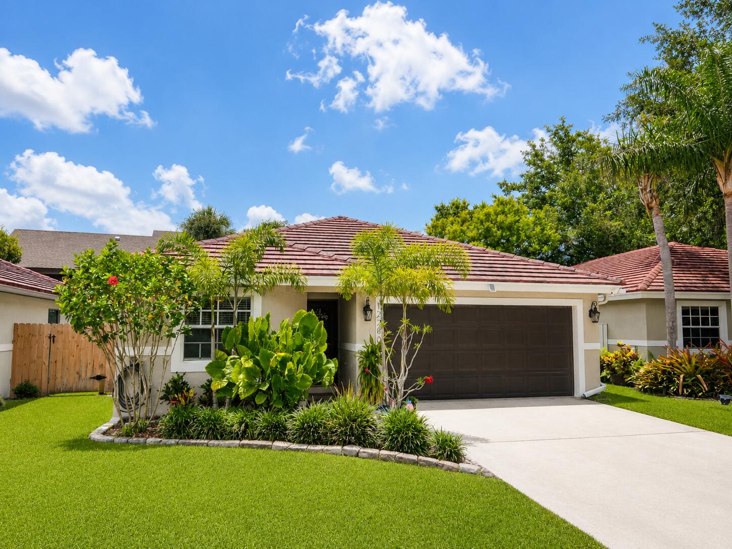 Lowest priced single-family home currently on the market in Wellington! Welcome to 12280 Dartmoor Drive, a beautifully maintained 3-bedroom, 2-bathroom smart home located in the heart of Wellington. This move-in ready residence offers an ideal blend of comfort, convenience, and modern upgrades, all within one of Palm Beach County's most sought-after communities. Step inside to discover upgraded features throughout, including an updated kitchen, beautifully refreshed bathrooms, smart thermostat, security system, spacious living areas, and a thoughtfully designed floor plan perfect for everyday living and entertaining. The home also features a two-car garage, hurricane shutter protection for added peace of mind, and numerous smart-home enhancements that make ownership both comfortable and convenient. One of the home's standout features is the screened patio/sunroom, providing additional living space to enjoy Florida's beautiful weather year-round while remaining protected from the elements. Just beyond, you'll find a private backyard retreat located at the end of the street, offering a safe and versatile space for children, pets, outdoor gatherings, or simply relaxing in your own tropical oasis. Location is everything, and this home delivers. Residents enjoy walking-distance access to two local parks, including the popular Scott's Place Playground, as well as the Wellington Amphitheater, home to year-round community events, concerts, food truck nights, holiday celebrations, and activities. Directly across the street is a preschool/VPK facility recognized with Florida's Gold Seal Quality Care accreditation, providing exceptional convenience. Access to highly regarded A-rated Wellington schools, while everyone will enjoy being just minutes from premier shopping, dining, grocery stores, fitness centers, equestrian venues, medical facilities, and major commuter routes. With a low HOA, modern smart-home features, updated interiors, hurricane protection, and an unbeatable Wellington location, this property offers exceptional value and lifestyle appeal. Whether you're a first-time buyer, seasonal resident, or someone simply looking to enjoy the Wellington lifestyle, 12280 Dartmoor Drive is ready to welcome you home.