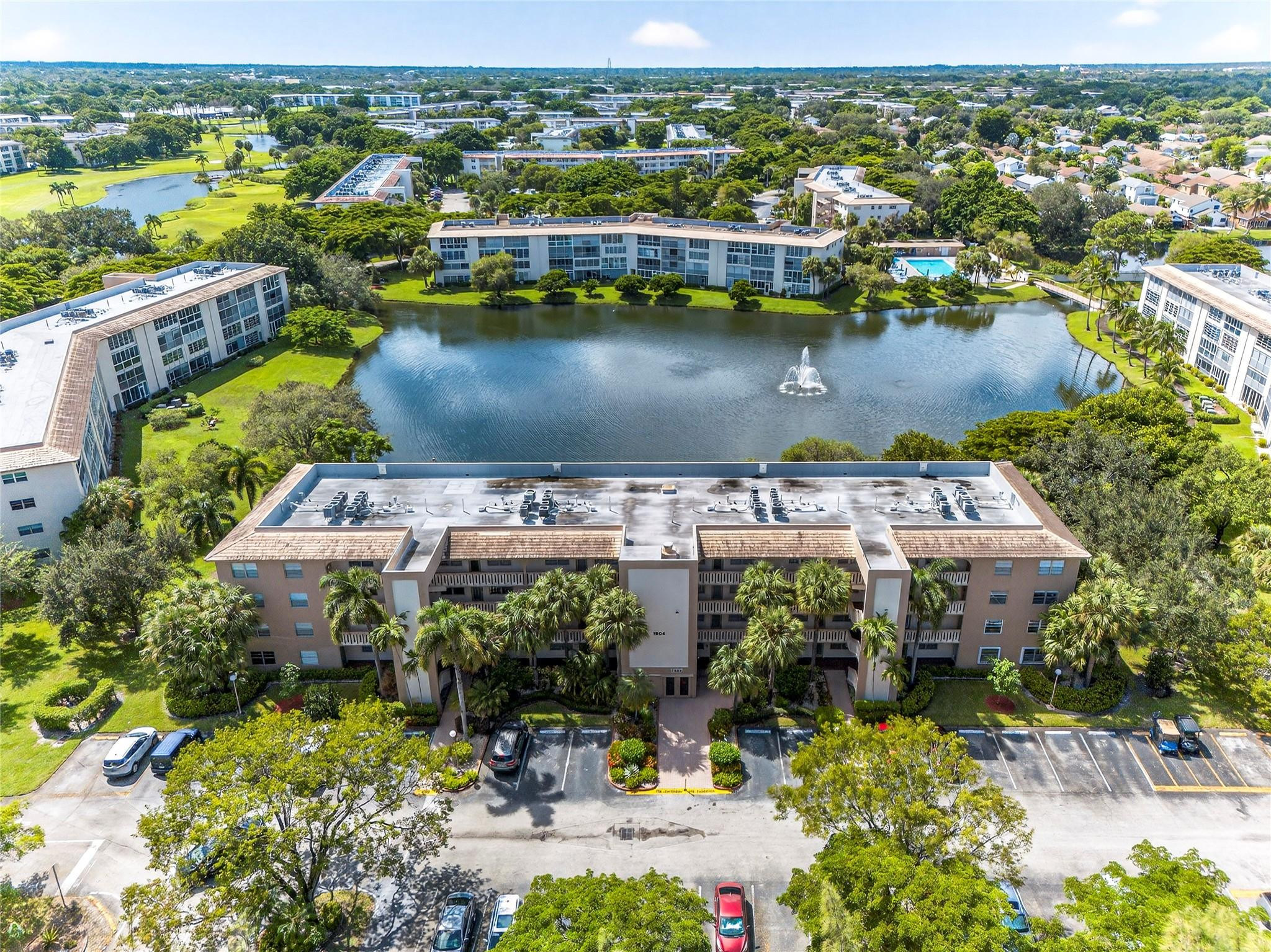 First-floor, fully renovated lakefront residence designed for the most discerning buyer. Features include premium stainless steel appliances, custom cabinetry, high-gloss tile flooring, and elegantly remodeled bathrooms. The enclosed patio, finished with A/C and impact glass, offers year-round lake views. Spacious bedrooms with large closets provide excellent storage. Located in Wynmoor, a premier 55+ community with golf, a 50,000-sq-ft clubhouse, dining, pickleball, fitness and social programs, and courtesy bus service. Move-in ready and truly exceptional. FIRST FLOOR — COMPLETELY RENOVATED LAKEFRONT HOME that will satisfy the most demanding buyer! Step inside to high-end finishes throughout: PREMIUM stainless steel appliances, CUSTOM CABINETRY,  high gloss tile flooring, and elegantly REMODELED BATHROOMS. The enclosed patio is FINISHED WITH AC and IMPACT GLASS so you can enjoy lake views in year-round comfort! Generous bedrooms and large closets provide plenty of storage. Located in Wynmoor, this home includes access to outstanding 55+ community amenities: golf, a 50,000 sq. ft. clubhouse with dining options, pickleball courts, courtesy bus service, fitness and social programs — everything you need for an active, resort-style lifestyle. Don’t miss this move-in ready lakefront gem.