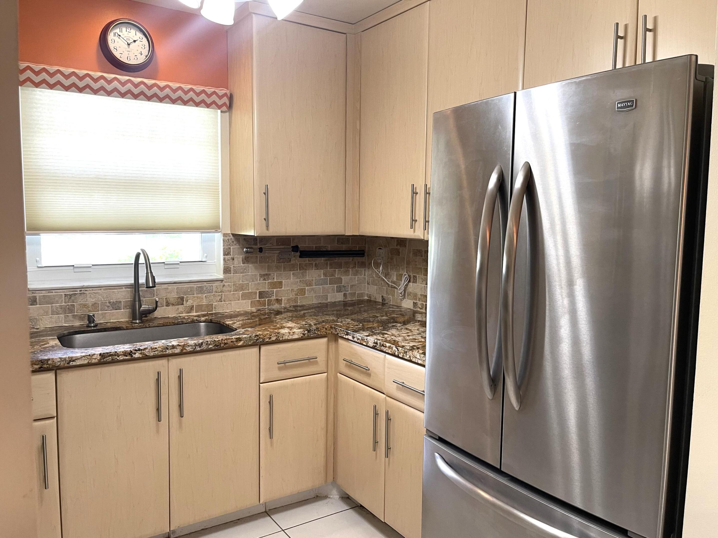 Pride of ownership is evident from the moment you step into this beautifully remodeled 2-bedroom, 2-bath corner villa in a highly desirable active 55+ community. This move-in-ready home features hurricane impact windows, a remodeled kitchen with newer cabinetry, granite countertops, tumbled marble backsplash, newer Maytag stainless steel appliances, a large stainless steel sink with a gooseneck faucet, and neutral tile flooring throughout with no carpet. Additional upgrades include updated guest and primary bathrooms, five ceiling fans, a custom dining room mirror, skid-resistant entryway tile, front and rear storm doors, and an enclosed air-conditioned Florida room perfect for a den, office, or additional living space. Major improvements include a new roof installed in 2021  The assessment was paid in full by the sellers; the A/C was replaced in October 2025, and a water heater was installed in June 2010. The villa is offered furnished for added convenience. Relax and enjoy peaceful canal views from the backyard while embracing the Florida lifestyle in this vibrant community, which offers a heated resort-style pool, clubhouse, pickleball courts, tennis courts, shuffleboard, and a full calendar of social activities. Ideally located just minutes from the beach and downtown Delray Beach, you'll enjoy easy access to charming boutiques, open-air cafes, fine dining, shopping, theaters, I-95, the Florida Turnpike, and places of worship.  Each building of four villas shares a conveniently prepaid washer and dryer.  All information is deemed reliable but not guaranteed and subject to change without notice.