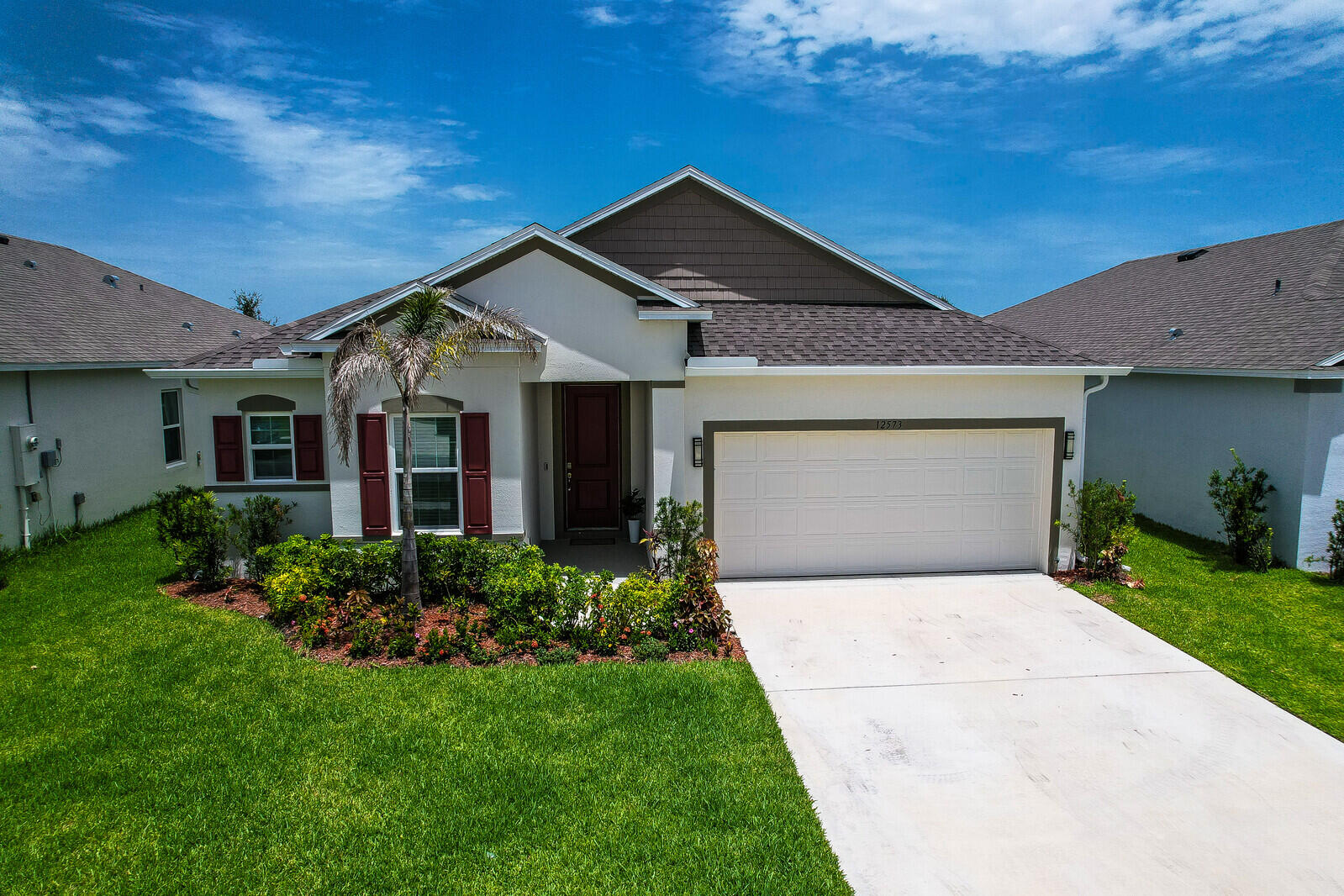 This stunning home features a bright, open-concept design centered around a gourmet kitchen with 42" shaker cabinets, quartz countertops, stainless steel appliances, a large island, and an additional windows that fills the space with natural light. The spacious great room and versatile flex space are perfect for today's lifestyle. Retreat to the luxurious owner's suite with double-door entry, a spa-inspired bath featuring dual vanities, a soaking tub, separate shower, and walk-in closet. Additional highlights include ceramic tile flooring, custom interior trim, impact windows, a screened lanai, and an open patio for relaxing or entertaining. Designed for modern living, this beautiful home offers the perfect combination of style, comfort, and functionality. Welcome to Central Park,  a vibrant master-planned community in the heart of western St. Lucie County, offering exceptional amenities and convenient access to shopping, schools, and hospitals.
