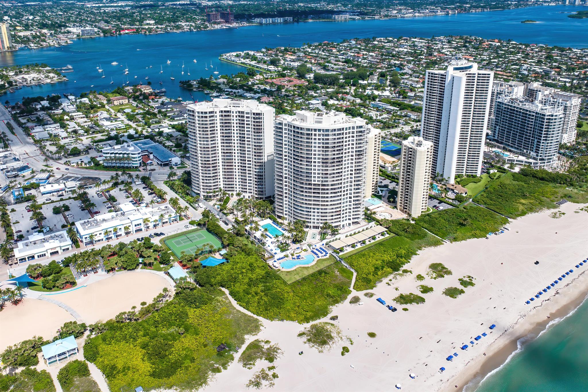 Directly on the beach, this spectacular former model home at the Ritz Carlton Residence is professionally decorated, with 2 private balconies. The primary balcony is ocean front to capture the spectacular sunrise - this extra-Large Covered Balcony is perfect for entertaining family and friends while the other is Intercoastal facing to capture the yachts as they sail by and take in the beautiful Florida sunset. There is a den/bonus room that could also be used as a 4th guest room. A Chef's kitchen with Italian cabinetry, Sub Zero refrigerator, built-in Miele Espresso Machine, Wolf appliances and Quartzite countertops. The private Elevator opens directly into your private lobby and into your home. The Ritz Carlton offers 5-star amenities including 2 pools, a private beach, 2 full gyms with sauna, valet, detailing, and private theater. Enjoy your own private restaurant on site with poolside service. The restaurant will also deliver meals to your home for that stay-in kind of evening! This condo includes 2 reserved parking spots in the garage under the building, and 2 downstairs self-contained storage units.