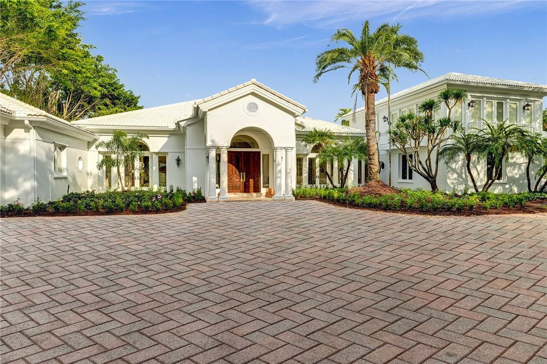 This Hurlingham Drive estate offers traditional luxury at stately proportions. Custom box molding adds lush texture, expansive gallery walls await your art collection, and soaring tray ceilings and gracious thresholds allow abundant sunshine to flow throughout the interior. Relax in your palatial yet tranquil primary sanctuary. Dual dressing rooms, a sunny sitting area, and a spa-worthy bath make it an ideal retreat for two. Entertain a crowd in the great room. The party will flow outdoors through the wall of French doors, revealing a resort-style patio and swimming pool. The golf course views are a perfect backdrop, whether you throw a casual pool party or a formal affair. A large kitchen offers plenty of counter space, designer appliances, and a butler’s pantry to prepare for guests. After everyone’s left, you’ll love spending the long South Florida days in your outdoor living room.