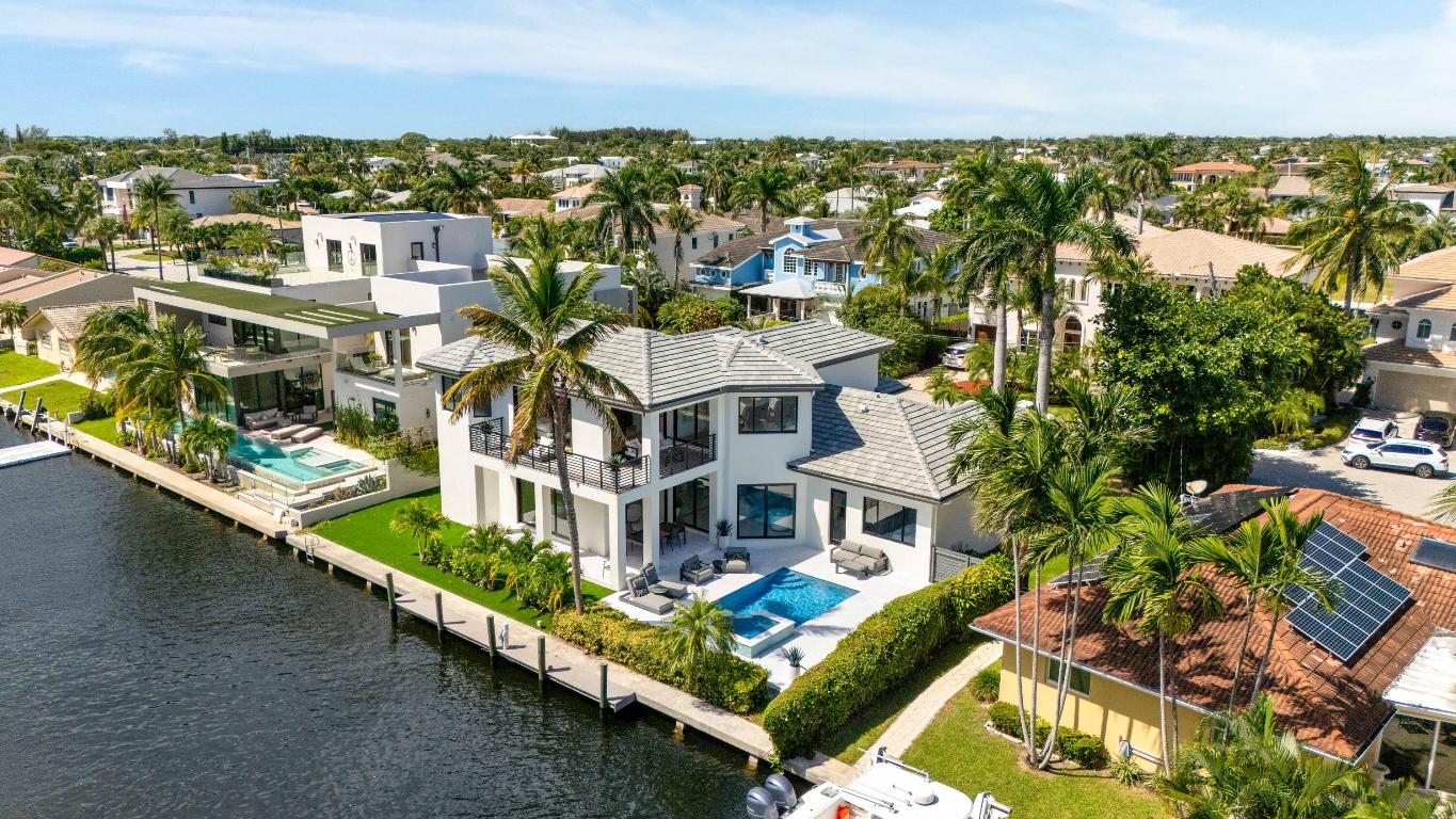 Welcome to this fully renovated waterfront home in East Boca Raton's highly sought-after Boca Keys community. With 90 feet of water frontage and a 40-foot dock just two homes from the Intracoastal, this residence blends modern design with thoughtful, high-end updates throughout. Inside, you'll find a seamless combination of porcelain tile and white oak flooring, a custom floating staircase crafted from white oak with open risers, and a dedicated wine cellar. The home is outfitted with code-compliant PGT hurricane impact windows and doors, ensuring top-tier storm protection.  The kitchen has been completely remodeled, featuring premium cabinetry, quartz countertops, top-of-the-line appliances, and a stylish designer backsplash. Step outside to enjoy a rebuilt marble pool deck, a brand-new paver driveway, and a newly constructed balcony with sleek modern railings, waterproof materials, and upper-level access ideal for soaking in waterfront views. A new roof adds the finishing touch, making this home truly move-in ready.
Perfectly positioned just 10 minutes from Mizner Park and 15 minutes from Town Center Mall, this property offers both exceptional convenience and a serene waterfront lifestyle.