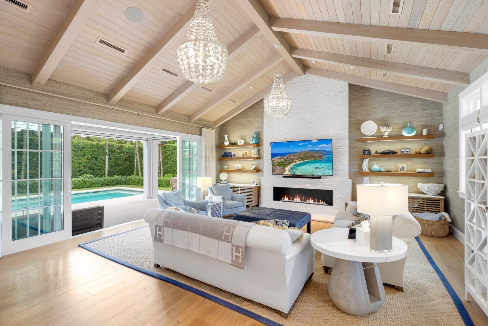 Stunning 4BR/4.1BA Island Colonial home custom built in 2017 and located on the sunny South side of Seagate Road. Open floor plan beautifully designed by Daily Janssen Architects. Living room features wall-to-wall pocket sliding doors, vaulted and beamed ceiling, and gorgeous brick fireplace. Light and bright dining room is lined with large windows. Pristine gourmet kitchen featuring Bianco Superiore Quartzite countertops, pantry, and oversized chef's island with seating for 5. Top-of-the-line appliances include 48'' gas range, wine fridge, microwave drawer, 30'' refrigerator and freezers, and dual dishwashers. Beautiful wood and marble tile flooring throughout. First floor primary suite features office, built-in cabinetry, and oversized bath and closet. 2 car garage leads to mudroom with bench and built-ins. Fabulous covered loggia features vaulted ceiling and motorized screens. Backyard with tropical landscaping, built-in grill, outdoor shower, spa, and 40' pool. Additional highlights include upstairs loft, full-house generator, and central vacuum system. Seagate residents have access to fantastic North Shore Beach Club which includes beach cabana with vaulted ceilings, dining area, waterfront patio, and hammock area.