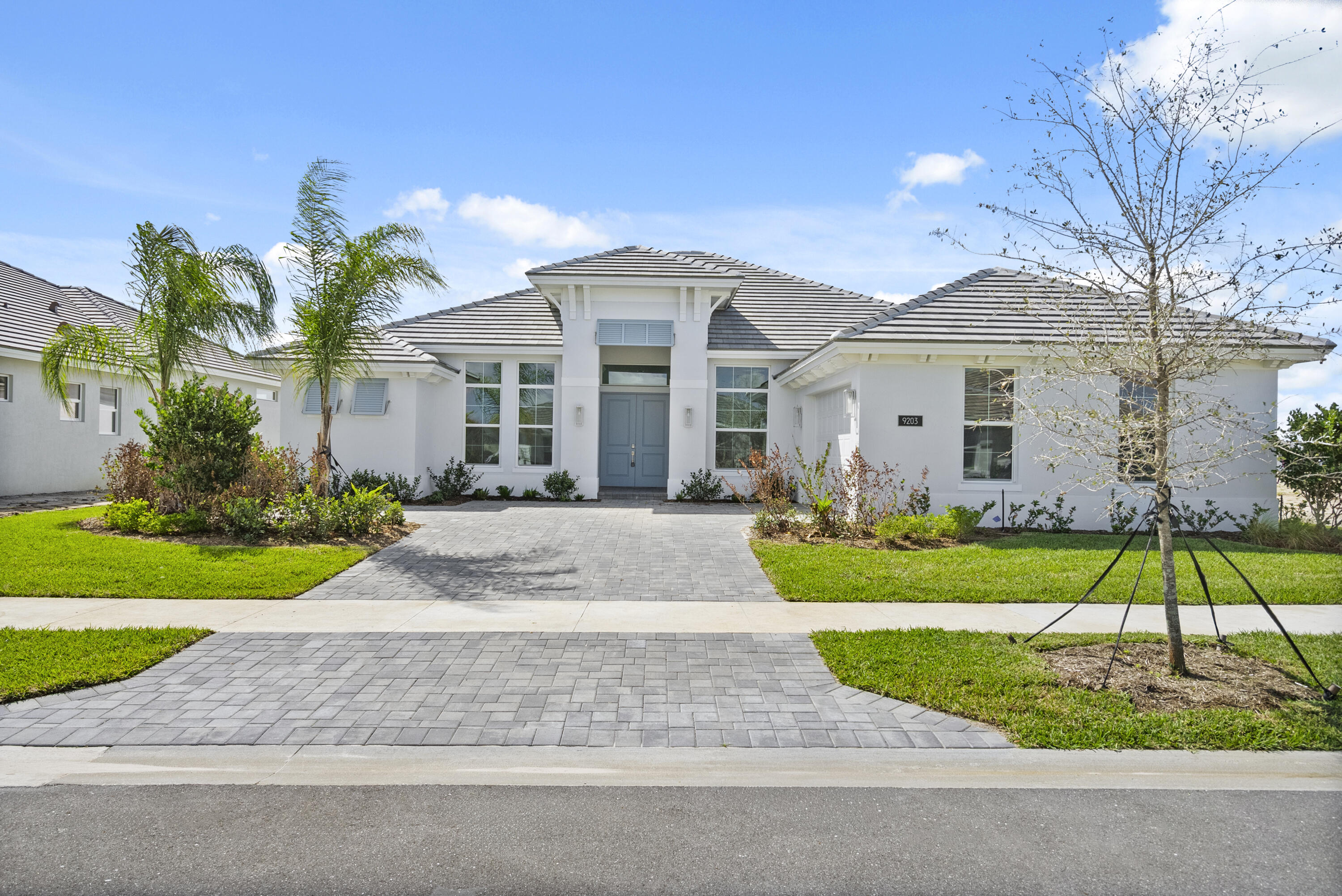 4 bedroom, 3.5 bath home with a den and 2-car garage showcases the elegant Coastal elevation and is thoughtfully designed with upscale finishes throughout. The heart of the home features a gourmet kitchen equipped with the GE Profile appliance package, upgraded quartz countertops, a Pelican single-bowl granite sink, and a kitchen convenience package for added functionality. The kitchen also includes two junction boxes above the island, ready for future pendant lighting, and opens to a spacious great room enhanced by 4 hi hats and a seamless flow into the dining room and office, all of which are also pre-lit. A bar with a built-in beverage center adds a touch of luxury and convenience for entertaining. The master suite is complete with an Aurelia free-standing soaking tub and spa-inspired finishes. Additional highlights include wood plank tile flooring throughout, tile-to-ceiling finishes in bathrooms 2 and 3, a pocket door for added privacy at bedroom 3, and prewiring for a wall-mounted TV on the covered patio. The home also features an enlarged pool with sun shelf, bubbler and panoramic screen enclosure, creating a private outdoor oasis with long lake views.
