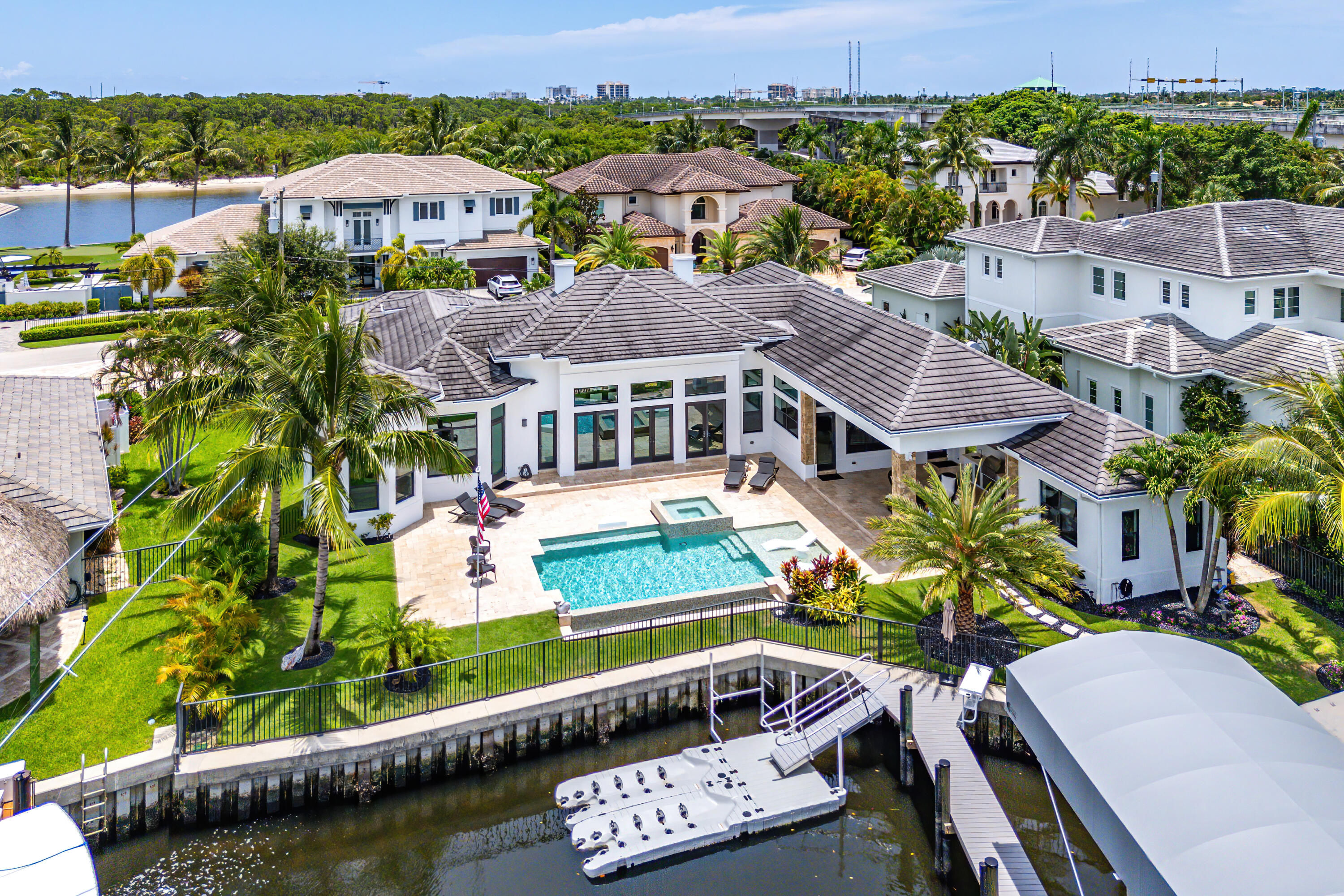 Waterfront Luxury Living in Prime Boater's Location!

Welcome to this exceptional waterfront residence offering over 130 feet of deep water frontage just one canal from the Intracoastal. Built in 2017, this custom-designed residence features 4 bedrooms and 4 baths, including a private guest house, all situated on a premium 1/3-acre lot at the widest point of the canal for optimal water views and turning radius.

The grand great room welcomes you with soaring 16' ceilings and breathtaking waterfront vistas. Ideal for boating enthusiasts, the property includes 4 slips (36 ft. -30,000 lb. lift , 34 ft. 14000 lb. lift , 55 ft., and a 28' water slip) just a one-minute ride to the Intracoastal. Crafted with the finest materials and attention to detail, the home boasts a chef's kitchen with a dramatic 3" quartz waterfall island, top-tier appliances, and sleek custom cabinetry with a  86" built-in TV. The open-concept design is perfect for entertaining, extending seamlessly to a resort-style saltwater pool and spa, travertine sun deck, and a covered lanai with a summer kitchen, TV,  hooded vent, and phantom screens.

Interior highlights include rectified wood-look tile throughout, Restoration Hardware lighting and hardware, Sonos surround sound throughout and outside deck, solid-core doors and trim, and a side-by-side subzero wine refrigerators. The luxurious primary suite offers a private office with bay windows, while the detached guest house includes a full bath and refrigeratorperfect for visitors or extended stays.  
Residence is also equipped a new security system with outside cameras along with charging station for electric vehicles. 

Pursuit DC 365 Pleasure / Fishing boat available separately'

This is coastal living at its finestideal for those who demand both elegance and functionality.