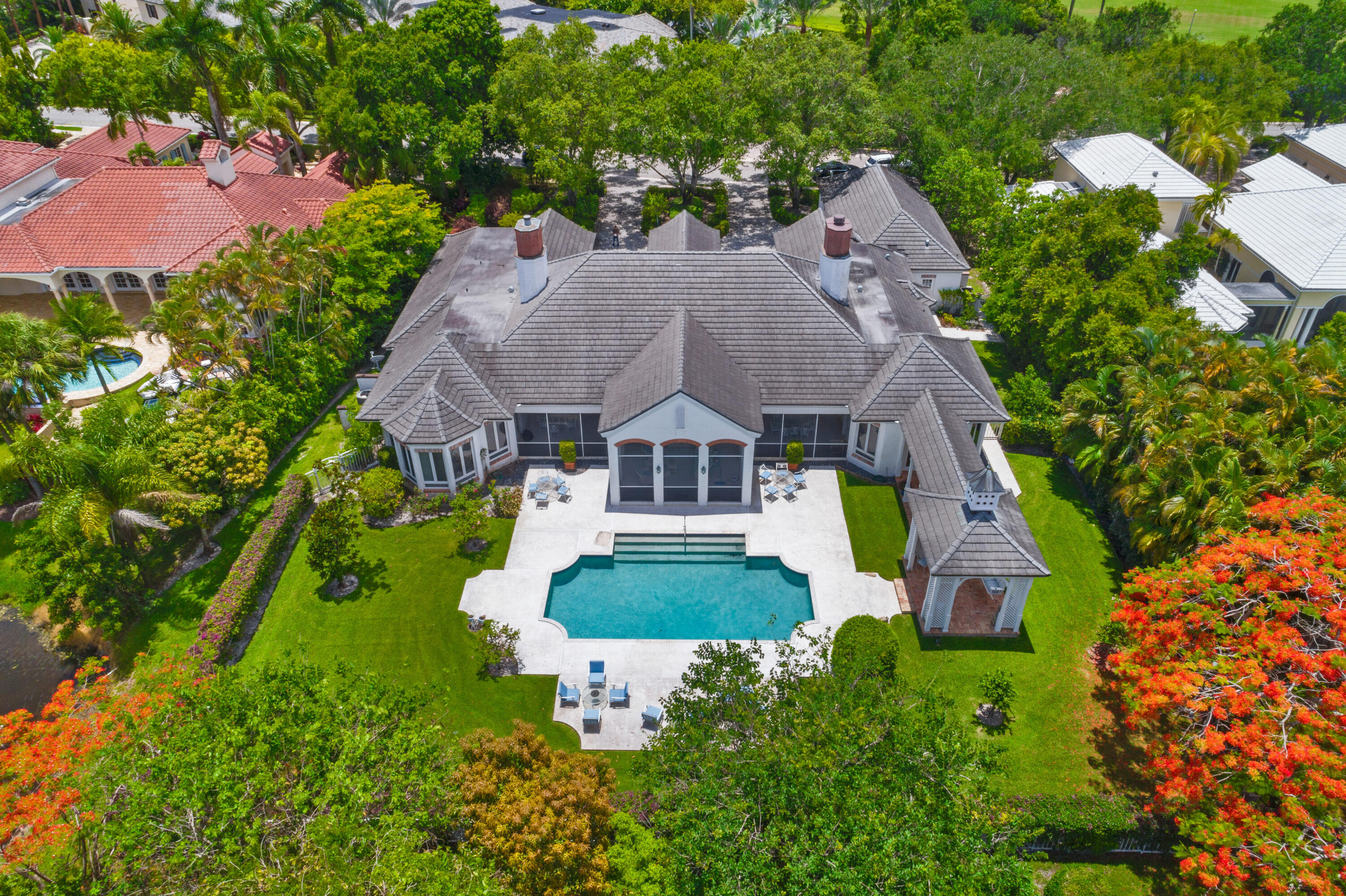 Traditional grace and class abound at gracious '' Le Marais'' well located within the elite gated Bridle Path estate section of Palm Beach Polo.  Totaling over 8,000 square ft  this spacious 4 bedroom 6 1/2 bath home with 3 car garage features sunny golf and lake views from the large screened patio, overlooking the beautifully designed pool. There is plenty of space to roam on this spacious more than 1/2 acre fenced  lot. The formal living and dining rooms feature tray ceilings  and open out onto the large brick screened patio. Perfect for gracious entertaining. The oak paneled study with fireplace and plenty of room for books, ads warmth to this grand home. Every bedroom is equipped with en suite baths and closets. The spacious master suite features his and her baths and closets and opens to the  backyard outdoor patio and pool.  Come add your personal touches to this well designed estate home and create a masterpiece.