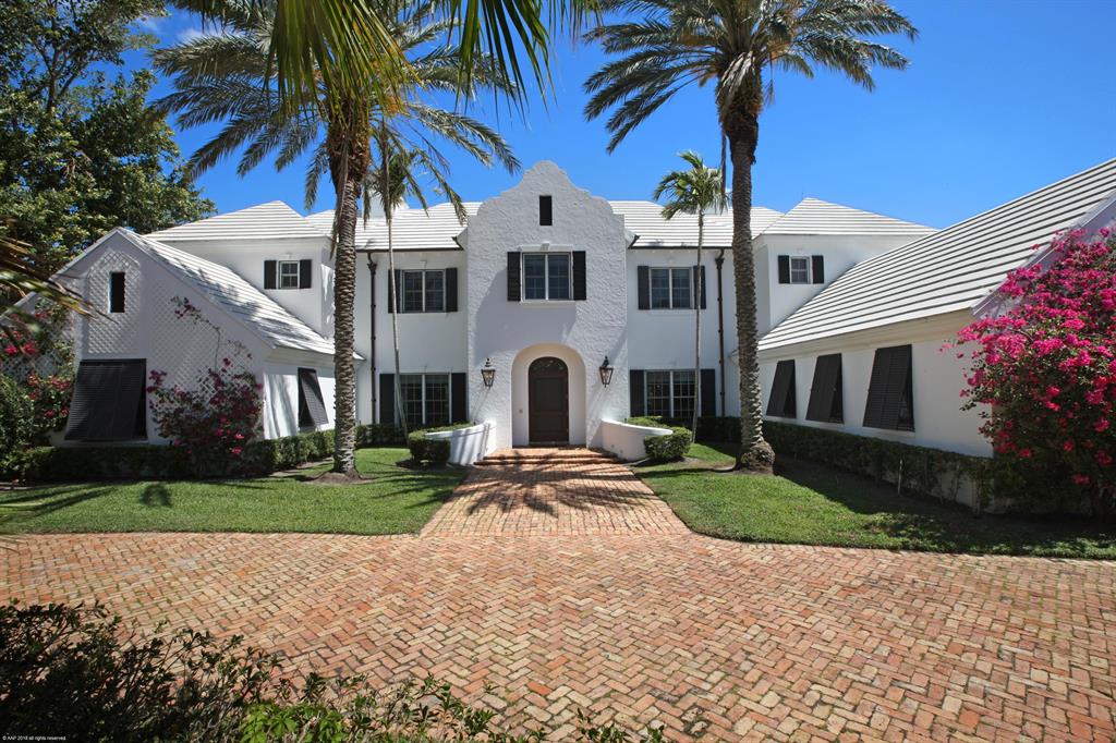 Impressive 5 bedroom, 5.5 bath British Colonial designed by architect Roger Janssen and built by Onshore Construction. Privately situated on 1.18AC lot w/150' frontage with dock & fenced yard. Seminole Landing is a highly sought after gated community w/tennis & deeded beach access. Perfectly proportioned rooms allow for formal entertaining yet casual living. Enjoy coastal breezes on expansive 1st and 2nd floor screened in verandas. Gourmet kitchen has granite counters & backsplash, stainless appliances, SubZero. Interior features include beautiful wood & natural stone floors, crown molding, Waterworks bath fixtures, central vac.  There are 2 separate garages with room for 3 cars. Bosch dishwasher, convection wall oven, island with vegetable sink & breakfast bar, walk-in pantry, and breakfast nook with bay window. 3 spacious guest suites, each with ensuite bath. 2 screened porches (both 48' long) w/fans & tongue in groove ceilings, open patio around heated pool, overlooking large fenced yard w/6 types of fruit trees. Hurricane shutters, quality construction w/poured concrete 2nd floor, 2 car garage w/2nd washer/dryer unit, separate air conditioned 1 car garage w/attic storage, brick circular drive. Ocean access. Great North Palm Beach location close to parks, beaches, restaurants, shopping, movie theater, & more!