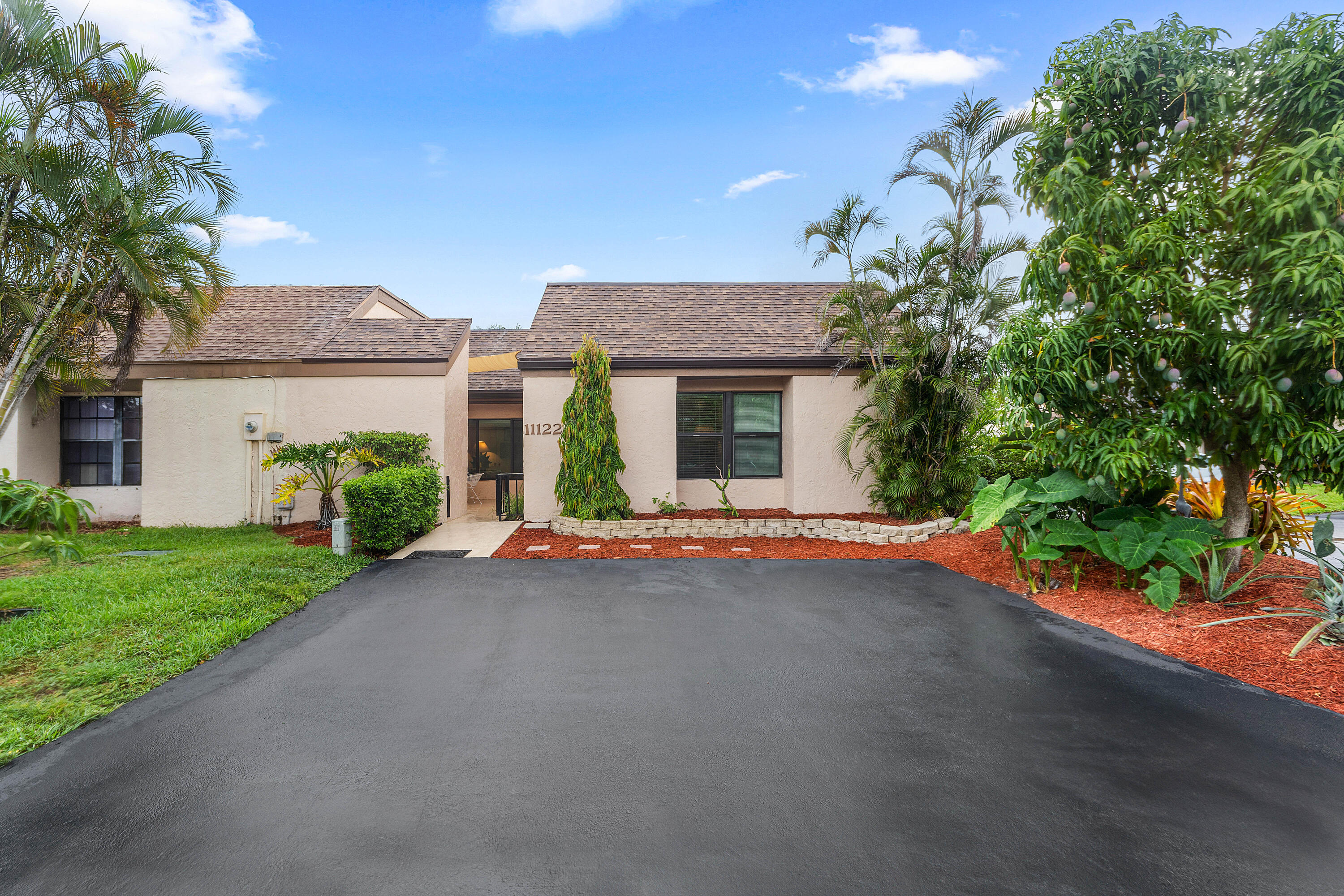 3/2 one level end unit villa featuring soaring high ceilings and an inviting split plan layout. A private courtyard welcomes you into this delightful, light airy space with a gorgeous lake view. Low HOA - $160/month. New Bosch appliances in the kitchen, Electrolux W/D, 2023 roof, 2026 A/C system, and impact glass for added peace of mind. The flexible third bedroom is currently set up as a home office, could be a great media room, or guest space. The generously sized primary suite offers a large soaking tub and an expansive walk-in closet. The back patio is perfect for grilling & entertaining. Tons of fruit trees and herbs on site!  Great school zones! Community pool, tennis and handball. Close to shopping, hospitals, major highways, fine dining and only minutes to the beach!
