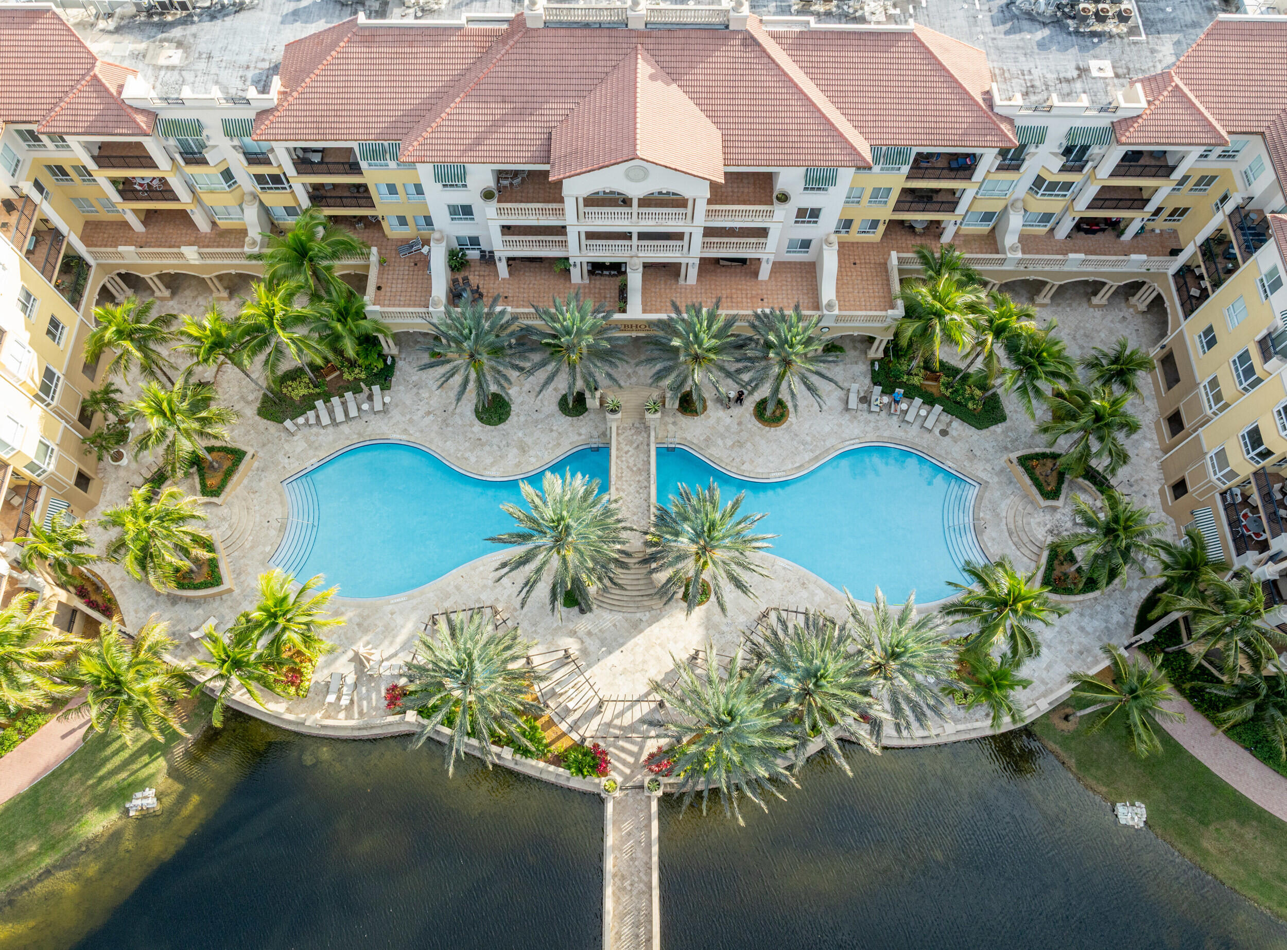 Experience the ultimate 55+ resort-style lifestyle at The Palms at Weston. Rarely available B Model located in the Clubhouse Building, offering one of the best locations in the community with stunning lake and pool views from an expansive private terrace. This spacious 2-bedroom, 2.5-bath residence features marble floors throughout the living areas and hardwood flooring in the bedrooms. Tastefully decorated & impeccably maintained, the home offers generous living spaces, abundant natural light, and a layout perfect for both everyday living and entertaining. Enjoy state-of-the-art amenities, beautifully maintained grounds, dining services, fitness center, social activities, and a vibrant active-adult lifestyle in one of Weston's most sought-after 55+ community. *Unit comes with one Storage*