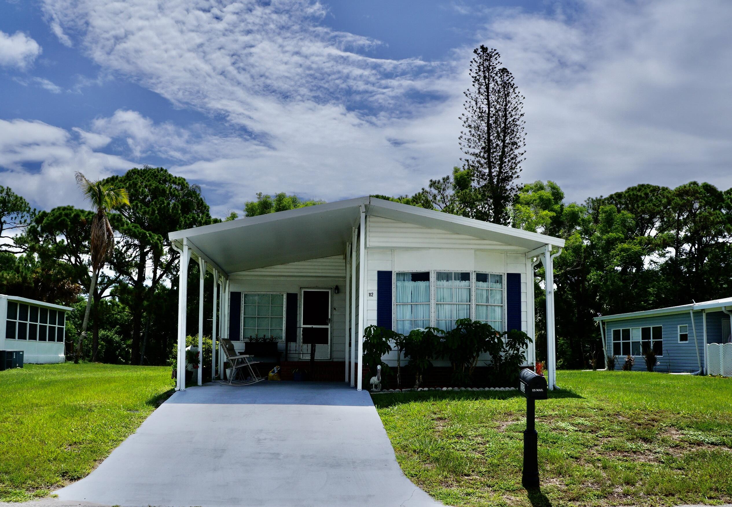 Welcome to this open concept, beautifully remodeled home! Clean and move in ready. No backyard neighbors, located on the golf course! Enjoy entertaining friends at your kitchen island. 2 bedrooms/2 baths, each on their own end of the home for privacy. This land leased home is located in the desirable Spanish Lakes Community.  This is a 55+ park that offers a relaxed lifestyle for those who are ready for a break. And for the active seniors, Spanish Lakes offers all inclusive, resort like, amenities with a clubhouse, FREE GOLF, social events, tennis, billiards, shuffleboard, swimming, fitness center, and more.  NO HOA fee, as your $1128.19 monthly land lease pays for everything, including your lawn care, trash removal, property taxes and community activities. This home is tucked away into a private community, yet within a few miles of the beach, hospitals, and shopping. Don't miss your chance to buy in Florida!