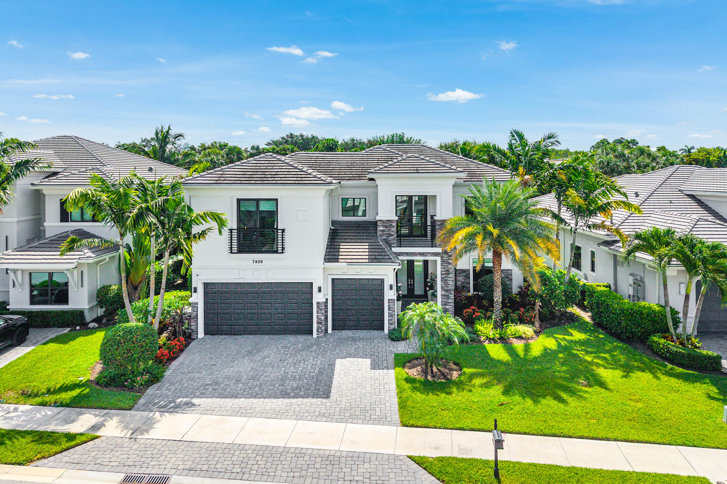 Elegant, inviting, and impeccably designed, this exceptional residence blends sophisticated designer finishes with effortless everyday living. Soaring ceilings, oversized windows, and new wide-plank wood flooring throughout create a warm, welcoming atmosphere filled with natural light, while the open-concept design allows each space to flow seamlessly from one room to the next.  At the heart of the home, the chef's kitchen is beautifully appointed with Wolf and Sub-Zero appliances, sleek custom cabinetry, an oversized island, and abundant storage, opening effortlessly to the expansive living and dining areas. Every detail has been thoughtfully curated, blending clean architectural lines with refined finishes to create a home that is both elegant and comfortable.  The luxurious primary suite is a true retreat, featuring the rare convenience of dual primary bathrooms, generous walk-in closets, and a private setting designed for relaxation. Spacious secondary bedrooms provide comfort and flexibility for family and guests.  Step outside to your own private backyard oasis, where lush landscaping creates a peaceful, secluded setting. Designed for year-round South Florida living, the outdoor space features a resort-style pool and spa, a covered lanai with a fully equipped summer kitchen, new turf with a putting green, and expansive spaces to relax, entertain, or enjoy time with family and friends. Additional highlights include a full-house generator, impact glass, and exceptional craftsmanship throughout. Located in one of Boca Raton's premier gated communities, residents enjoy resort-style amenities, a convenient central location close to shopping, dining, and major highways, and access to A-rated schools.