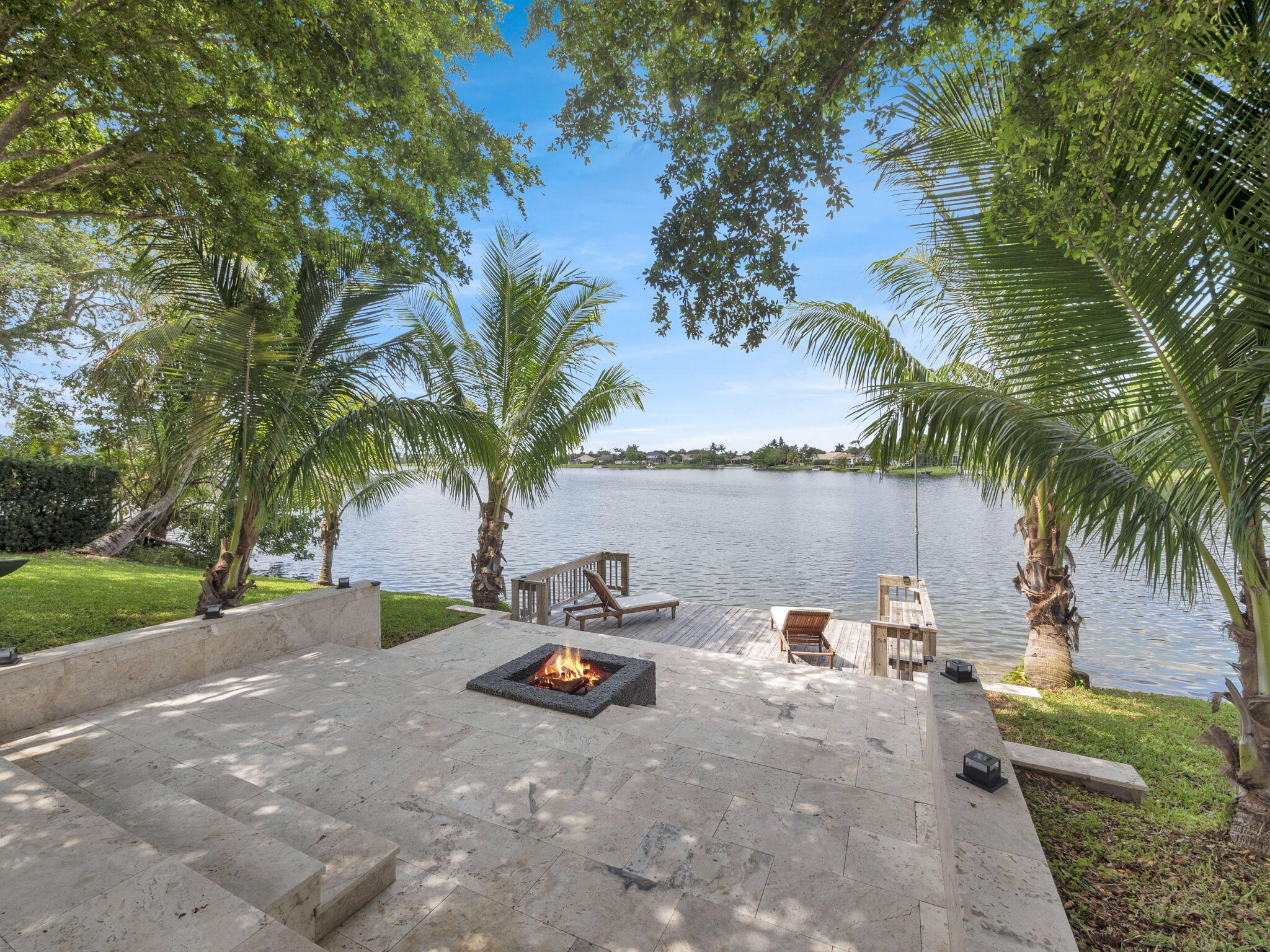 Exceptional waterfront living in the heart of Wellington. This stunning fully renovated residence offers modern luxury with breathtaking lake views, a private dock, a heated screened pool, and seamless indoor-outdoor living, ideal for both relaxing and entertaining. The open-concept layout features spacious living areas, a beautifully designed modern kitchen with a central island and high-end finishes, along with a beautiful primary suite. Enjoy direct water access and expansive outdoor living spaces. Renovations have been permitted and approved! Located in a gated community near top-rated schools, shopping, dining, and Wellington's renowned equestrian venues. Furniture negotiable. Buyer to verify all measurements, HOA information, and restrictions. Renovation permits have been finalized and approved. Living area reflects approved permitted plans.