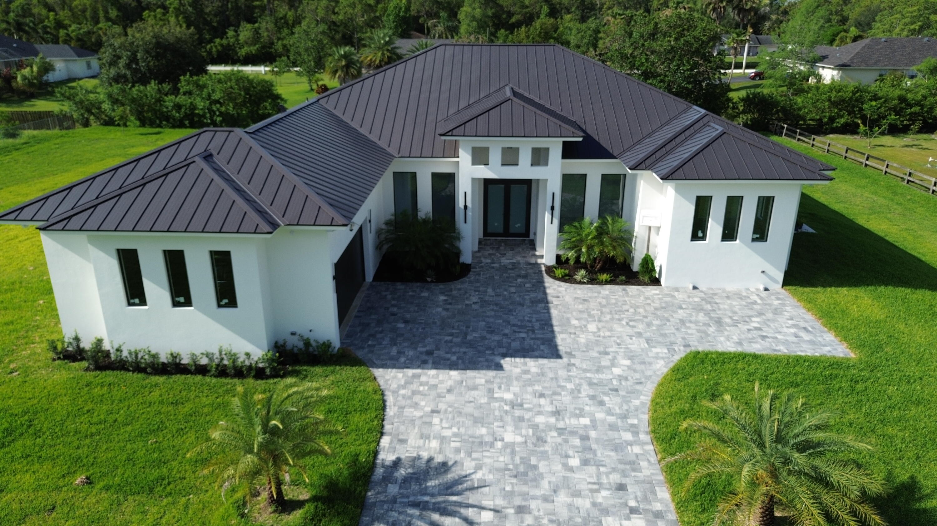 Gorgeous New Construction CBS House on 1.2 acres in the heart of Loxahatchee on a paved main road. This 4-Bedroom,4-Full Bathroom Open Floor-plan with High Ceiling.Spacious kitchen with lots of Cabinets.Primary Suite with Dual sinks, Separate Soaking tub, separate shower. Large walk-in closets. Oversized laundry room. Impact windows and doors. Water filter system.