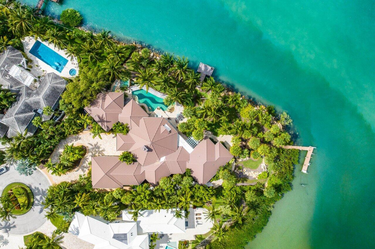 This spectacular waterfront estate is located on nearly an acre of land with 291 ft of waterfront. The home offers stunning views of the endless blue water and is perfect for entertaining with its spacious layout and lush tropical landscaping.

The home features 5,438 square feet of living space with 4 bedrooms, 4.5 baths, and a 2.5 car garage. The pool is 50 feet long and is surrounded by lush landscaping.

This home is perfect for those who love the waterfront lifestyle and want a home that is both spacious and luxurious. * Whether you're a boater, golfer, or tennis player, the community has it all, including a full-service marina just 59 miles from the Bahamas and minutes from the inlet, able to accommodate up to 125 foot vessel. The Sailfish Point Community is also located within minutes of a Private airport suitable for landing large private aircraft  Witham Field  Stuart Florida with US Customs on-site. Sailfish Point offers the ultimate Florida resort lifestyle with its oceanfront country club, fine & casual dining, Har-Tru tennis courts, Jack Nicklaus "Signature" golf course, state-of-the-art fitness center & spa, helipad, 1.5 miles of gorgeous beach, and 24/7 guarded & patrolled security for peace of mind. Don't miss this once-in-a-lifetime chance to own a piece of luxury oceanfront living!