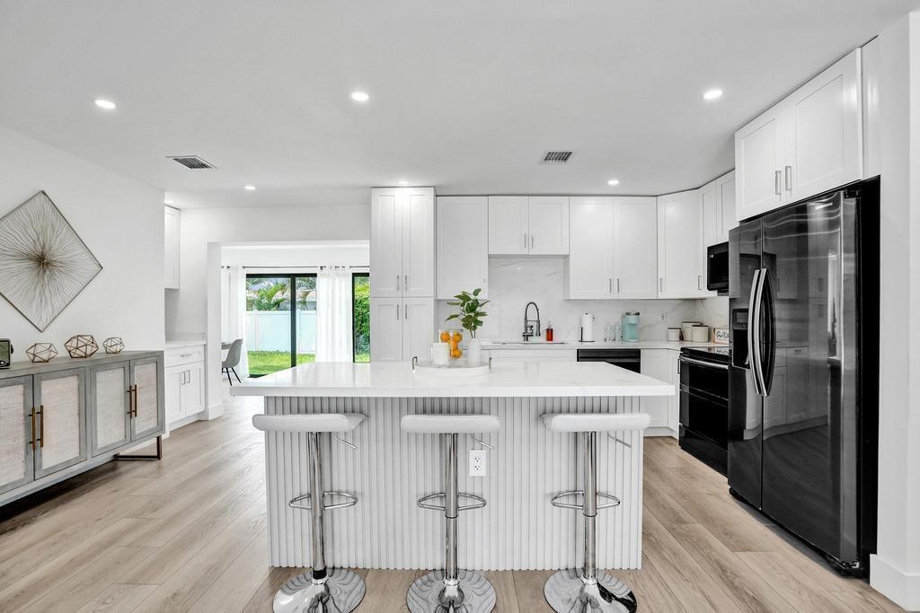 Welcome to this charming, updated residence in Deerfield Beach. This beautifully furnished four-bedroom, three-bathroom home offers 1,699 square feet of thoughtfully designed living space, ideal for comfortable everyday living and entertaining. The open floor plan provides ample room to relax, while the updated kitchen features elegant quartz countertops and stainless-steel appliances. Conveniently located just north of Sample Road, this home offers quick access to shopping, dining, and entertainment. Best of all, you're less than two miles from the beautiful beaches of Deerfield Beach, allowing you to enjoy the best of South Florida living.