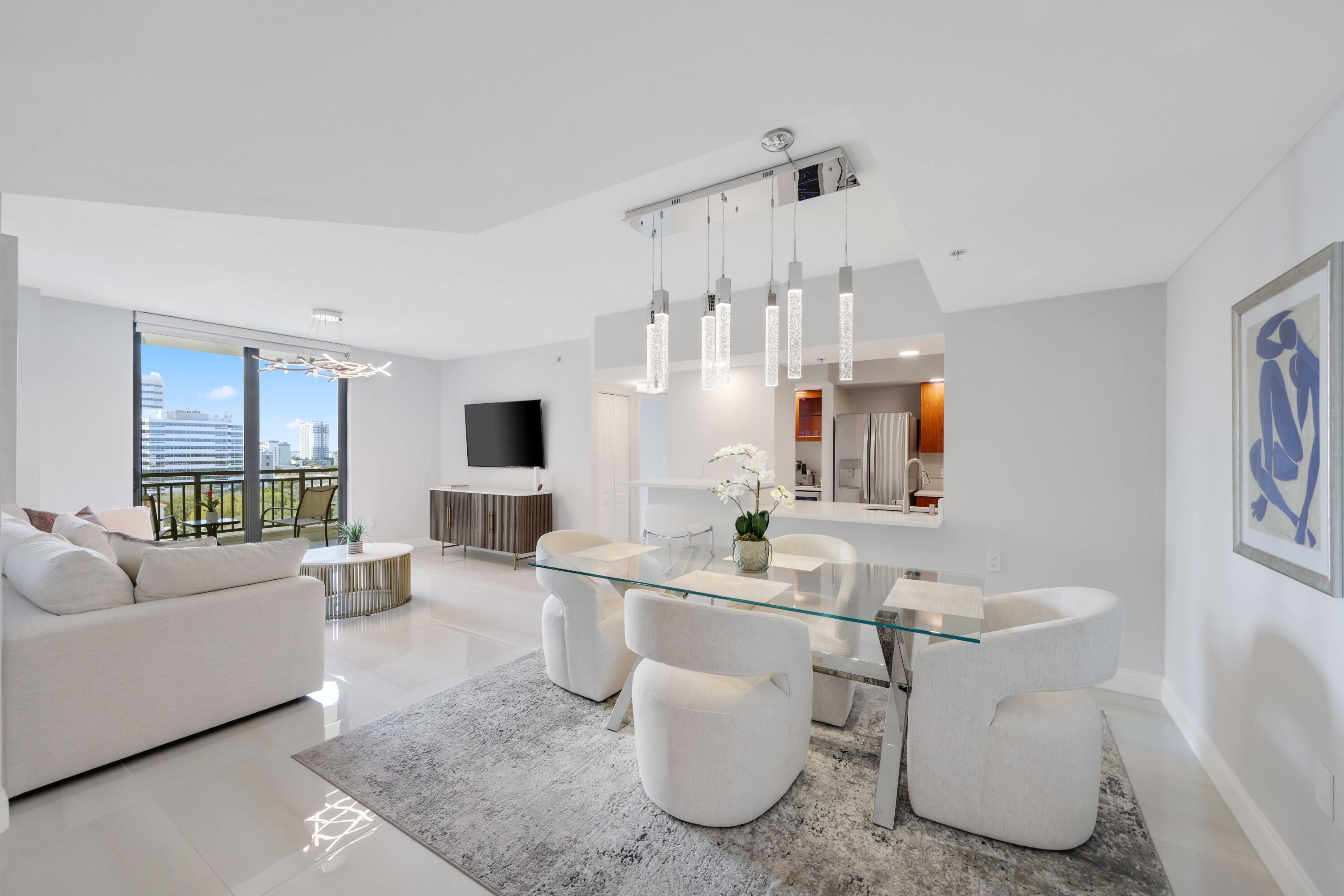 Experience elevated downtown living in this impeccably renovated 10th-floor residence at The Waverly at Las Olas. Offering 2 bedrooms, 2 bathrooms, and 1,259 square feet of thoughtfully redesigned living space, this exceptional home is one of the building's most desirable residences, featuring a rare open-concept entryway that creates an expansive and inviting floor plan.  Designed with both style and functionality in mind, every detail has been carefully curated. Oversized 36" x 36" porcelain tile flooring (2023) flows seamlessly throughout the interior and onto the private balcony, complemented by premium stainless steel appliances, motorized zebra blinds, designer lighting, and contemporary finishes throughout. The split-bedroom layout provides privacy and comfort, while the in-unit laundry adds everyday convenience.  Additional upgrades include a newer 3.5-ton HVAC system (2023), newer hot water heater (2022), and impact-resistant windows and sliding glass doors with upgraded stainless steel tracks and rollers (2023), providing effortless operation, energy efficiency, and peace of mind.  Step outside to your spacious private balcony and enjoy breathtaking west-facing skyline and sunset views over downtown Fort Lauderdale, an amazing setting for morning coffee or evening cocktails. The Waverly offers an exceptional collection of resort-style amenities, including a heated swimming pool, state-of-the-art fitness center, clubroom with wet bar, theater room, valet service, secured lobby, and professional on-site management. The community is financially strong with fully funded reserves, Fannie Mae approval, no pending special assessments.   Situated just steps from the vibrant restaurants, shopping, nightlife, and entertainment of Las Olas Boulevard, Riverwalk, Brightline Station, and only minutes from Fort Lauderdale Beach, this residence offers the very best of South Florida living.  Complete with an assigned parking space, premium upgrades throughout, and one of the most desirable floor plans in the building, this move-in-ready residence presents a rare opportunity to own an exceptional home in one of downtown Fort Lauderdale's premier condominium communities.