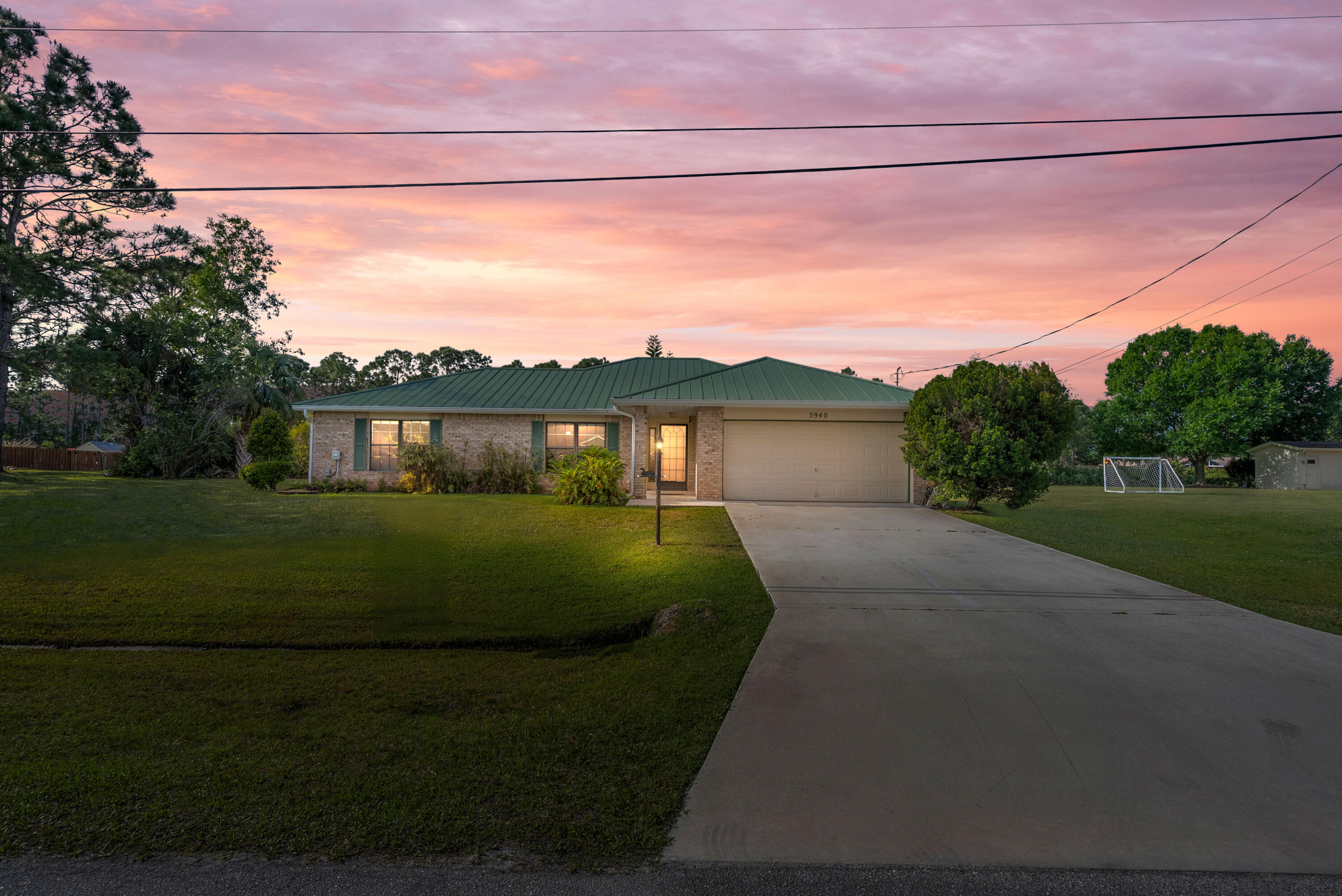 Welcome ! This  bright and charming three bedroom, two bath, garage CBS home offers comfort, space, and an excellent opportunity to live in the desirable Torino neighborhood of St. Lucie West.   Sit and enjoy your coffee with peace and unencumbered lush green backyard views.  So close to your own paradise and enjoy being just minutes from Clover Stadium, the home of the St. Lucie Mets, perfect for baseball fans and those who love the excitement of game days. Featuring a durable metal roof, bright and open layout, and a spacious family room, this home provides relaxed living in a prime location with easy access to major highways, shopping, & dining.