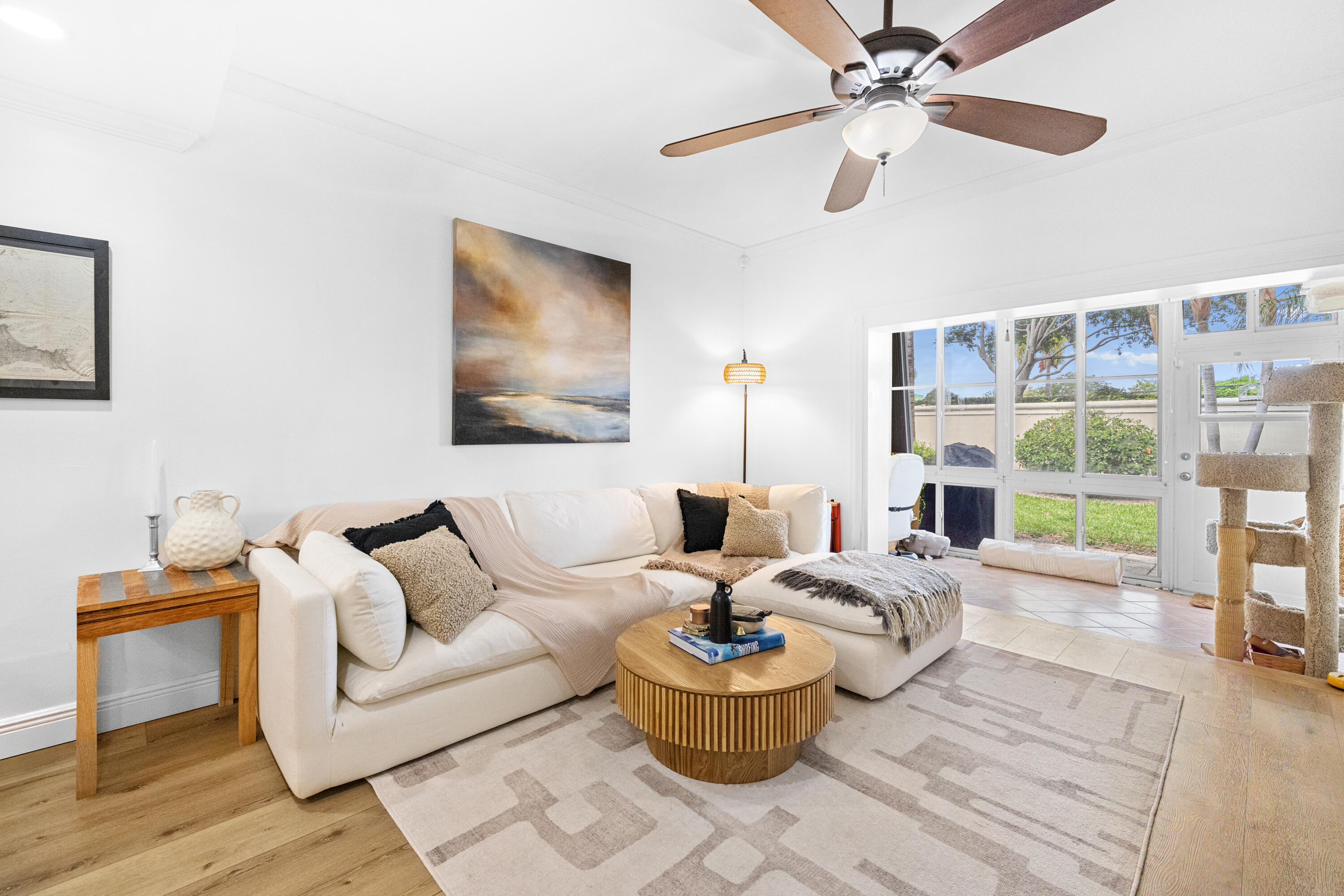 Welcome to your coastal retreat in the highly sought-after gated community of Kokomo Key, perfectly situated just east of Federal Highway and minutes to downtown Delray Beach, Atlantic Avenue, and the ocean. This spacious and beautifully updated townhouse offers 2 large bedrooms and 2.5 bathrooms, including a convenient main-level half bath. Filled with natural light from oversized windows, the home features a generously sized primary suite with an expansive closet, updated bedrooms, and brand-new natural-style luxury vinyl plank flooring throughout. The kitchen is equipped with newer stainless-steel appliances, complemented by a freshly painted interior. Additional upgrades include a 2019 A/C and full accordion shutters for complete storm protection.  Enjoy added living space with a glass-enclosed patio overlooking one of the largest backyard areas in Kokomo Key—offering exceptional privacy with no rear neighbors and a large adjacent green space perfect for pets and outdoor enjoyment. Kokomo Key is a waterfront Intracoastal community offering resort-style amenities including a heated and chilled saltwater pool, clubhouse, BBQ area, basketball hoop, park, playground, and a gated boat/RV storage yard. Residents also enjoy exclusive access to a private dock, scenic boardwalk, gazebo, and sundeck directly on the Intracoastal. Pet-friendly and investor-friendly (rentals permitted after the first year), this community is known for its welcoming atmosphere and unbeatable location. Take a short bike ride or drive to the vibrant shops, dining, and nightlife of Atlantic Avenue or spend the day at the beach just minutes away. Don't miss this rare opportunity to own in one of East Delray's hidden gems.