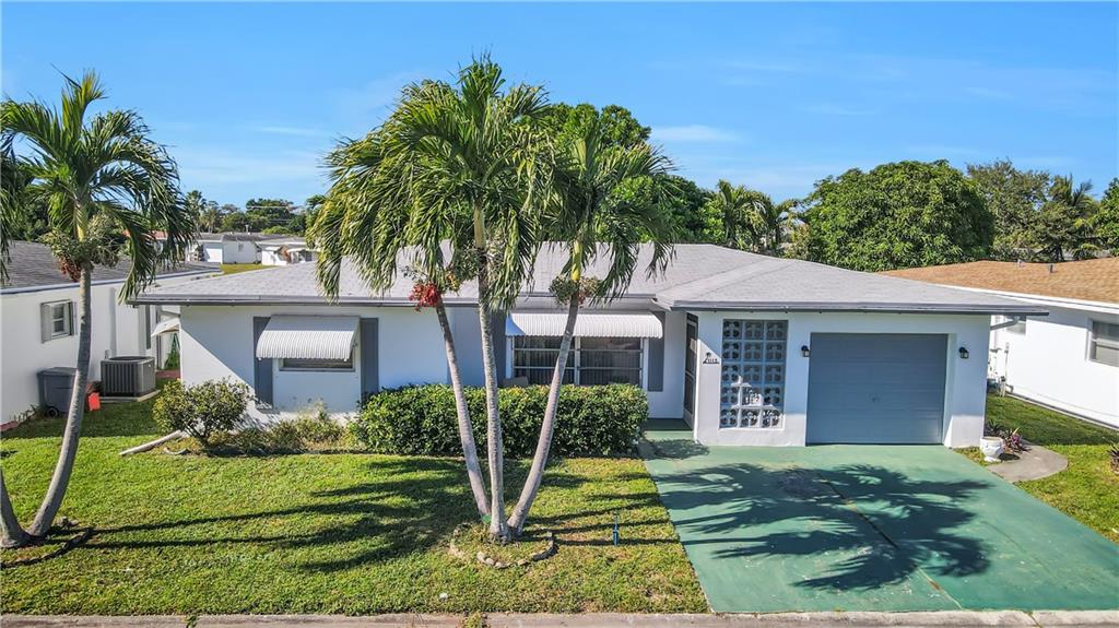 Welcome to Paradise!! This beautiful 2 bed/2 bath waterfront home, one car garage, is located in the desirable 55+ Community, Paradise Garden Section IV in Margate. With a total of 385 newly painted (2020) single-family homes in this community, the association is a self-managed Home Owner's Association. Tile Floors throughout, laminate flooring in the bedrooms along with updated bathrooms. The patio is fully enclosed and overlooks the water. The porch has hurricane shutters as well. The roof was replaced in 2018. The exterior of this home was painted by the association in 2020. The low HOA fees are only $241.00 quarterly or $80/Monthly which include access to the community pool, clubhouse, lawn care and exterior paint.