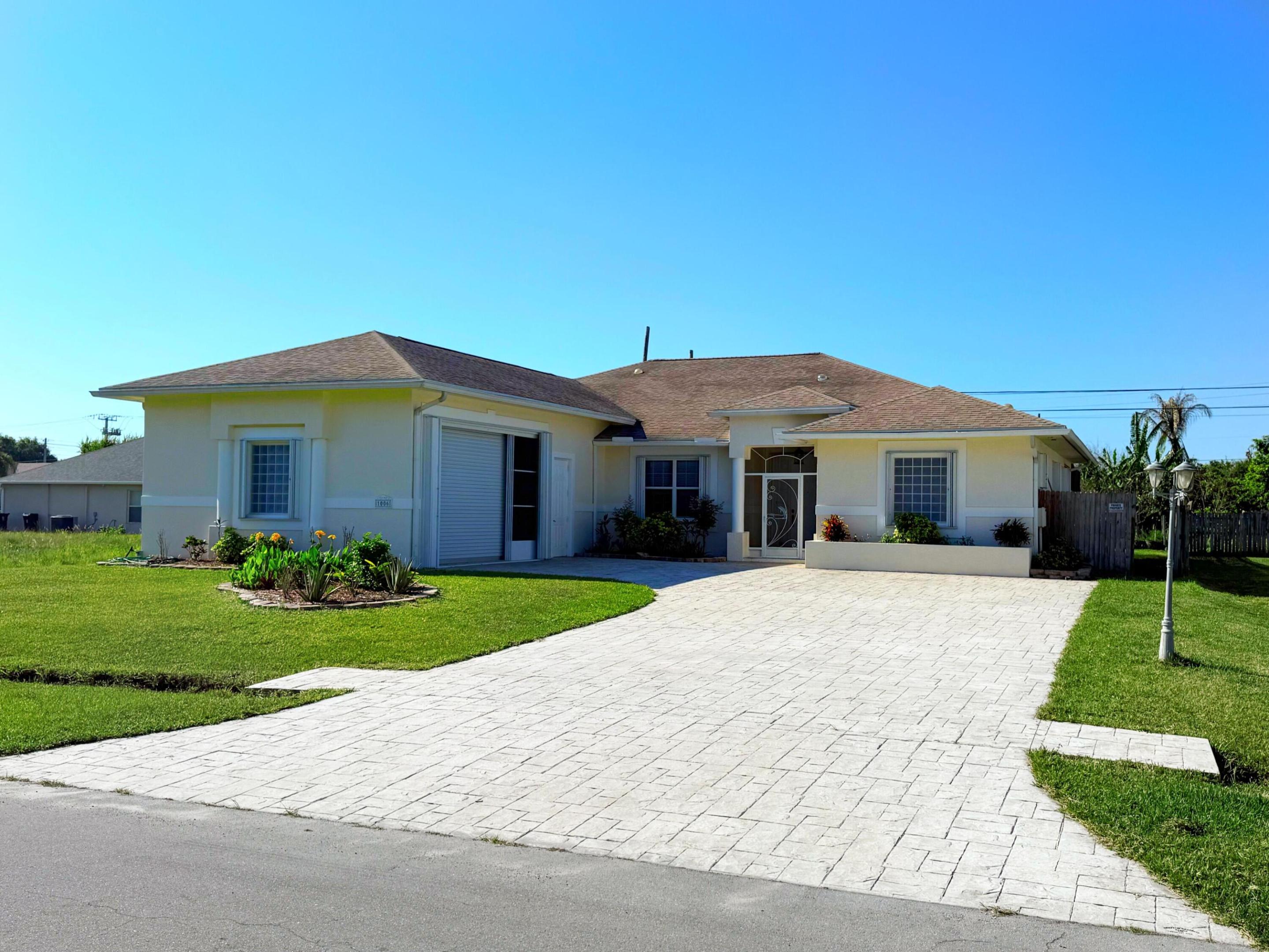 Spacious 3-bedroom, 2-bath in-ground pool home with standout features and no HOA.  Enjoy an open layout with 10-14 ft ceilings, new vinyl flooring, a large kitchen with abundant cabinetry and granite counter space, a living room with a mirrored wall, and a separate family room. Dual A/C systems provide added comfort and efficiency. The master bedroom features 2 walk-in closets and a spacious bath with a soaking tub and separate shower.  Additional highlights include a screened in-ground pool with heating capability, accordion hurricane shutters, a sprinkler system, central vacuum, skylights, an expansive stamped concrete driveway, and an oversized garage/workshop space with 12 ft ceiling. Built as a builder's personal residence, this home showcases quality materials and thoughtful construction throughout. Selling as is.