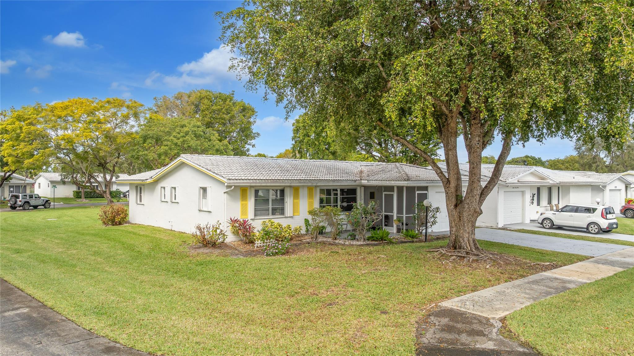 Welcome to Lauderdale West! This move in ready home sits on a private corner lot w/ no direct rear or side neighbor offering added privacy & space. The home features 2 bedrooms plus an air-conditioned Florida room, ideal as a third bedroom or home office. Highlights include a spacious family room, formal dining, a large eat-in kitchen w/ wood cabinetry, granite countertops, stainless steel appliances (newer refrigerator), crown molding, wood-look porcelain tile flooring, brand-new washing machine, smooth ceilings (no popcorn) & accordion hurricane shutters. The reasonable association fee covers lawn care, exterior pest control, house painting, basic cable / internet, roof repair / replacement and access to community amenities including clubhouse, gym, tennis, pool, shows & activities.