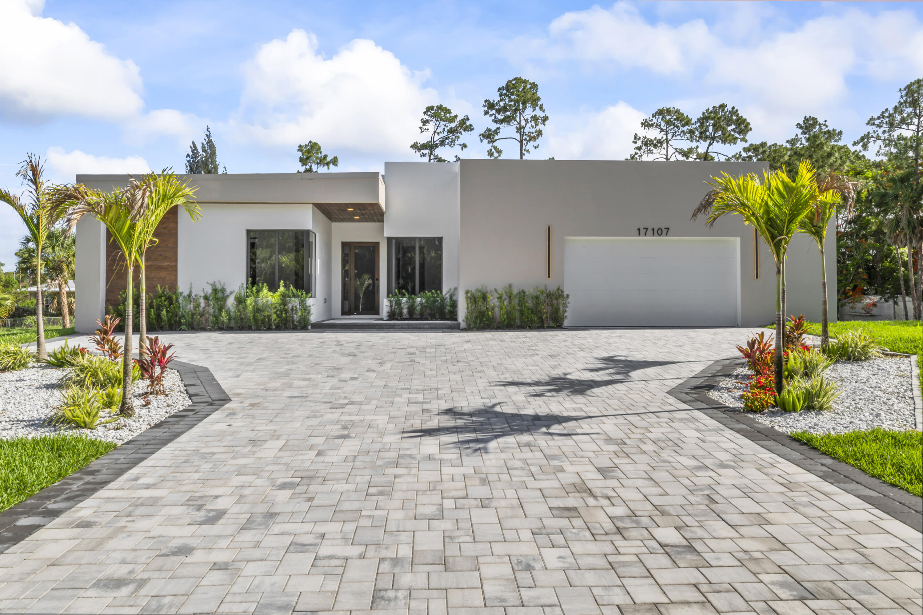 Exceptional New construction in Loxahatchee featuring 5 bedrooms, 4.5 bathrooms, and a two-car garage. This luxury home offers an open-concept layout with abundant natural light, a custom kitchen with premium finishes, and impact windows and doors throughout.  Enjoy true Florida living with a private pool and a fully equipped summer kitchen, perfect for entertaining. The property also includes a top-of-the-line whole-house water filtration system for superior comfort and water quality.  Situated on a generous lot in a peaceful, no-HOA community with easy access to schools, shopping, and major roadways. Move-in ready and designed for refined, modern living.