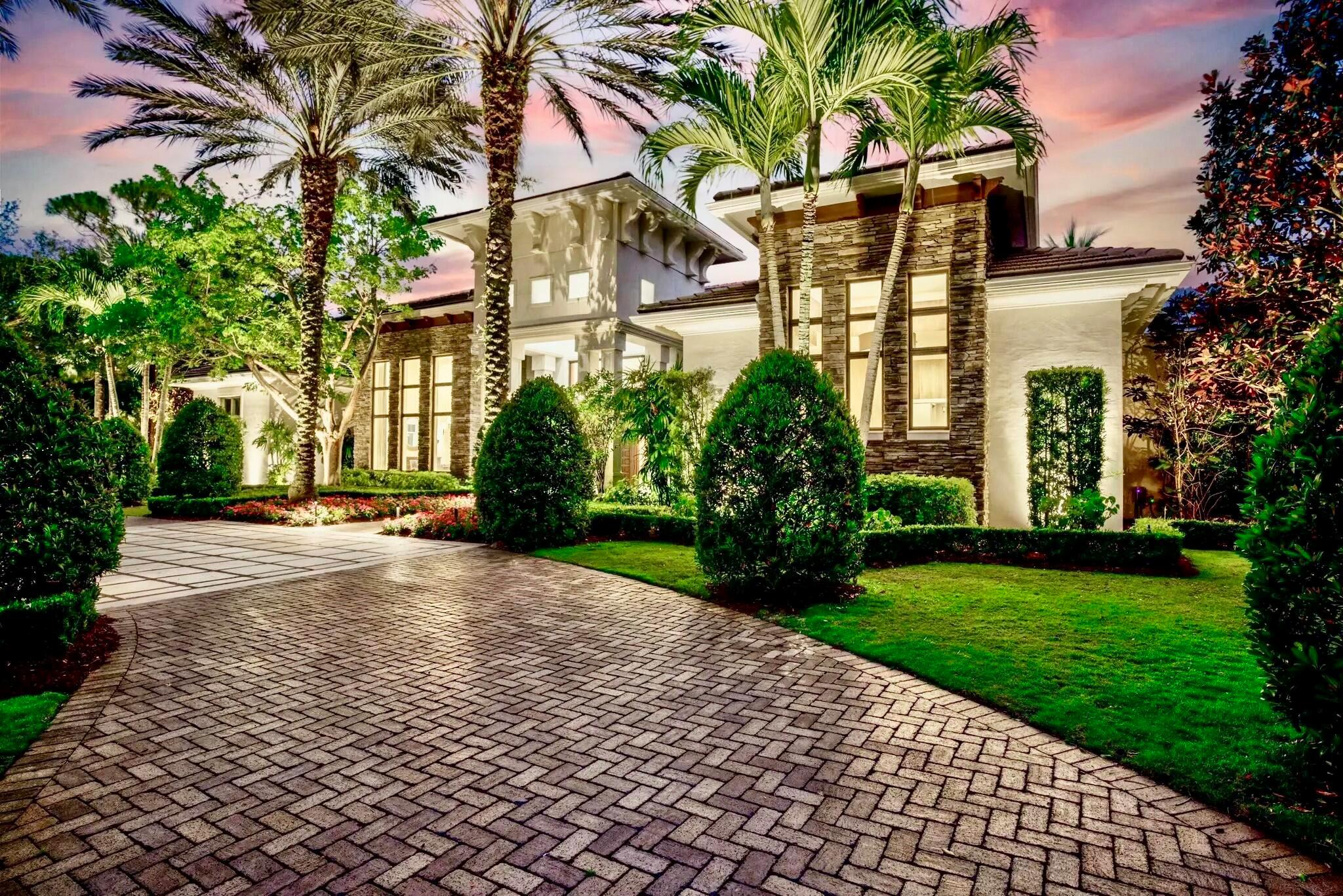 This secluded, single-story custom luxury home is situated on one of the most coveted streets in Old Palm Golf Club, where each homesite spans a full acre. Positioned at the end of a cul-de-sac and backing onto one of Old Palm's private nature preserves, this residence enjoys one of the finest lots in the community. Old Palm Golf Club, an exclusive gated enclave in Palm Beach Gardens, features a newly renovated Raymond Floyd Signature golf course, an upgraded clubhouse, and a state-of-the-art 20,000-square-foot lifestyle center. Club amenities include a new fitness center, spa, resort-style pool, lap pool, fine dining, sports bar, and guest casitas. All these exceptional features are just moments from your doorstep. The backyard is a true oasis with ideal southern exposure. The expansive covered loggia includes a fully equipped outdoor kitchen with a gas grill, ice maker, and a bar that seats seven, alongside dining and living spaces arranged around a cozy fireplace with a mounted television above. Step out from the covered area to a custom heated pool and spa with a calming rock waterfall, or unwind by the firepit under the stars with your favorite glass of red. The backyard also features a 1,100-square-foot synthetic turf putting green and chipping stations, perfectly positioned throughout the space for practice. Set on over an acre of land with a large fenced yard of lush zoysia grass, this property provides endless entertainment for all in a beautifully designed recreational paradise.

The grounds are breathtaking, with a meticulously crafted landscape that leaves no detail overlooked. Majestic oaks and magnolias grace the front yard, lending a refined, modern Low Country feel to the home's elevation. In the evenings, the landscape comes alive with a new, state-of-the-art low voltage system of lights that turns this backyard into a great entertainment venue. Carefully placed flowers, annuals, and lush shrubbery create the impression of a perfectly manicured estate.

Inside, the home is modern, spacious, and bathed in natural light, thanks to oversized impact-resistant sliding glass doors and windows. Custom ceiling details combine finely crafted level 5 drywall coffers with rich maple and mahogany beams. The millwork is of the highest quality, and additional spaces include a study, gym, custom fireplace, wine room, and home theater with upgraded electronics.

The expansive kitchen is a culinary dream, featuring double islands, double sinks, double dishwashers, professional-grade Thermador appliances, a reverse osmosis water filtration system, quartz countertops, and custom wood cabinetry. Adjacent to the kitchen and family room sits the wet bar with an icemaker and wine refrigerator that makes it ideal for entertaining both indoors and out. A Sonos Wi-Fi-controlled sound system fills the home with music, perfect for creating any atmosphere.

For hosting overnight guests, the home boasts a dedicated guest wing with a private entrance, formal living room, breakfast bar, and three private guest suites, each with its own full bath. Both the kitchen and living room have been fully refurbished and updated. Recent upgrades include a new roof, new ice makers, a new outdoor refrigerator, four A/C units installed in 2022, tankless water heaters, and a comprehensive water filtration system.

Throughout the interior and exterior, fresh new paint enhances the beauty of the home, complemented by new landscape lighting, updated landscaping, and epoxy-coated garage floors. Additionally, a full-house Generac generator ensures seamless power continuity. The Old Palm Golf Club membership is available but not mandatory for this exceptional home.