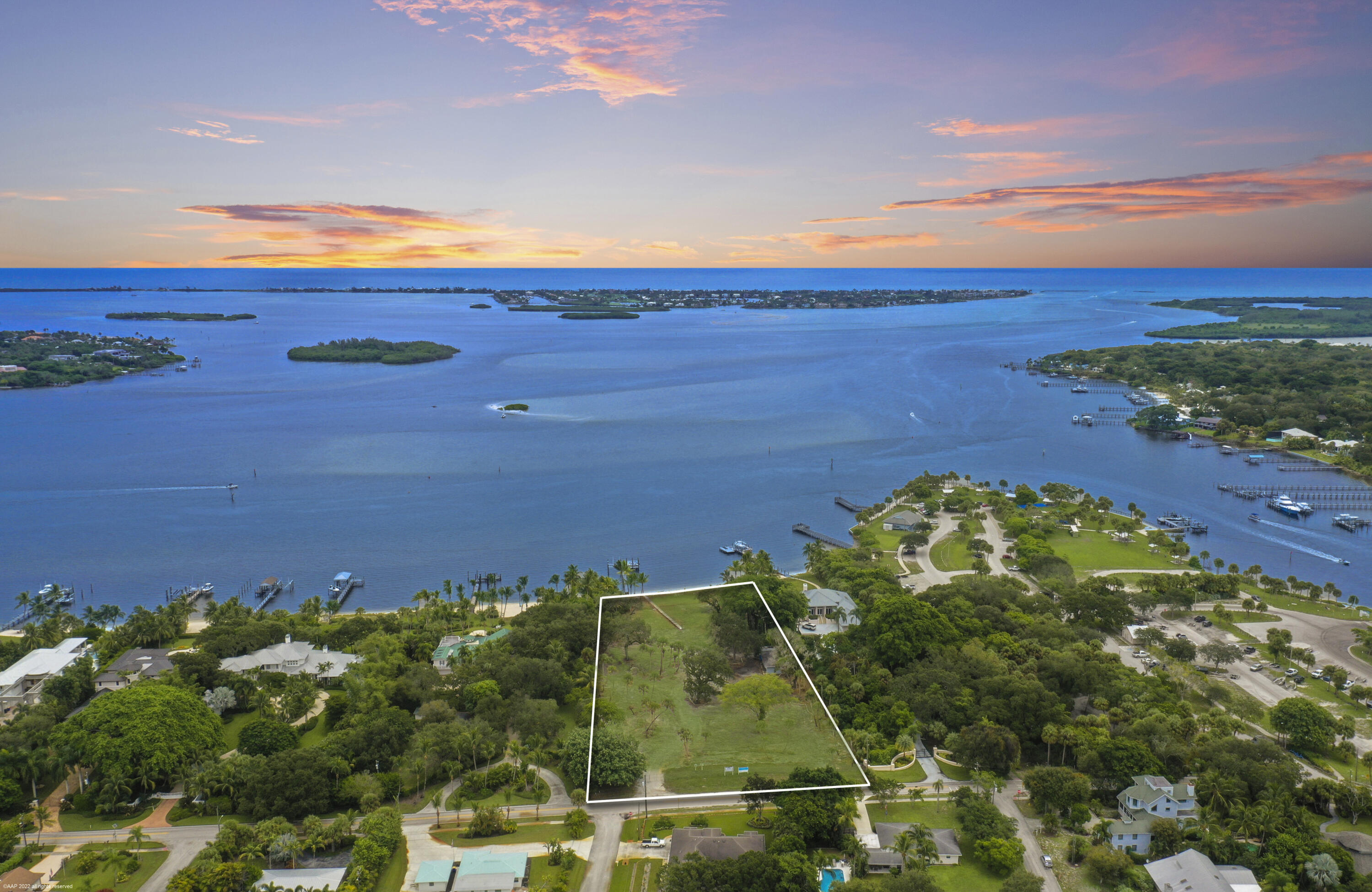Incredible double lot with 250' of sandy beach and aqua blue inlet water on over three buildable acres with direct views of the Saint Lucie Inlet.  Elevation of 25' above sea level offer excellent panoramic views and near constant gentle ocean breezes. The property has abundant old growth southern trees strategically placed within the property and along the perimeters for maximum privacy.  Private waterfront is protected from waves and boat traffic by an inner sandbar. New over engineered ipe dock and boat lifts with electric and fresh water.  Much required site work has already been completed making it ''shovel ready'' which will save months of construction time. New irrigation well for landscaping on site. Design plans available, permitted for house, guest house, gate house and boat house.