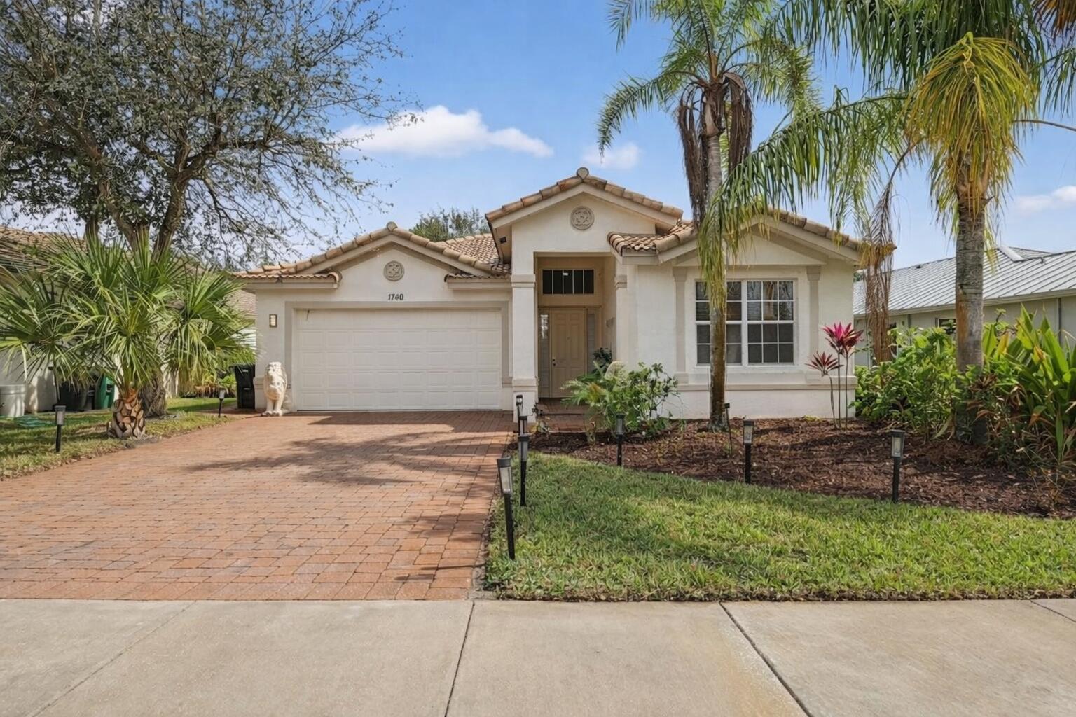 Refined, upgraded residence in the man-gated community of Portofino Isles, offering a true split floor plan and dramatic vaulted ceilings that enhance natural light and overall scale. This home stands apart with oversized 31 x 31 Italian porcelain tile throughout, creating a seamless, modern look rarely found at this price point.  The kitchen has been thoughtfully upgraded for both style and function, featuring granite countertops, stainless steel appliances, custom cabinetry, double wall ovens, and a designer range hood, making it a true focal point for everyday living and entertaining. Tailored zebra window treatments are custom-fitted throughout, including the main living areas and sliding glass doors, adding both privacy and a refined finish.  A spacious laundry room adds everyday convenience.  The primary suite is designed as a private retreat, offering two walk-in closets and a spa-style bathroom with a walk-in shower and separate soaking tub. Enjoy Florida living year-round from the screened-in patio, overlooking a private backyard with no rear neighbors.  Located in one of Port St. Lucie's most desirable gated communities, Portofino Isles offers resort-style amenities including a clubhouse, swimming pool, fitness center, tennis courts, basketball courts, pickleball, and playground, all with low HOA fees.