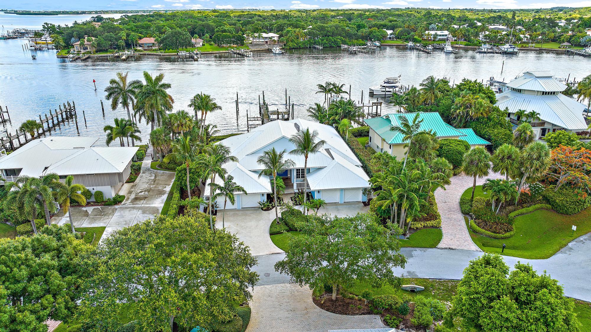 Charming waterfront oasis on the Historic Manatee Pocket.  Welcome to 4205 SE Centerboard Lane, a stunning residence nestled in the heart of Stuart, Florida. This enchanting property seamlessly blends classic coastal elegance with modern comforts, offering a serene escape in one of the area's most coveted locales.  Situated in the renowned Manatee Pocket, this home offers unparalleled access to scenic waterways, boutique shopping, and fine dining. Enjoy the vibrant charm of Stuart while being just minutes away from beautiful beaches and lush natural preserves.  As you enter this elegant home, you're greeted by an open and inviting layout that seamlessly integrates indoor and outdoor living. The spacious living areas are adorned with high ceilings, large windows and exquisite finishes, creating a bright and airy atmosphere perfect for both relaxation and entertaining.

The noteworthy feature of this residence is its backyard, a true boater's paradise. The private dock, just a stone's throw from the back door, has proudly hosted a 63' American Custom Yacht and a 69' Real Ships Expedition Yacht, underscoring the dock's exceptional water depth and functionality. Whether you're a seasoned mariner or a leisurely cruiser, this direct waterfront access offers the ultimate convenience and a gateway to endless nautical adventures.

The home boasts classic Florida architecture with a welcoming façade, lush landscaping, and a spacious covered porch ideal for sipping morning coffee or relaxing with an evening cocktail.  The meticulously landscaped grounds enhance the property's appeal, providing a serene setting to unwind and enjoy the picturesque water views. Imagine spending your evenings on the expansive deck, watching the sunset over the tranquil waters of the Manatee Pocket.

Enjoy a thoughtfully designed open floor plan featuring high ceilings, elegant crown molding, and rich hardwood floors. Natural light pours through large windows, illuminating the airy living spaces and highlighting the home's sophisticated style.

The heart of the home, the gourmet kitchen, is a chef's dream. Equipped with stainless steel appliances, custom cabinetry, and a generous island with seating, it's perfect for both everyday meals and entertaining guests.

The master bedroom is a private sanctuary, complete with a spacious layout, a walk-in closet, and an en-suite bathroom featuring dual vanities, a soaking tub, and a separate steam shower.

The outdoor living space is designed for relaxation and recreation. The backyard features a sparkling pool, a shaded patio area, and manicured gardens all creating a perfect setting for outdoor gatherings or peaceful solitude.

The property includes multiple guest bedrooms, a versatile home office or den, and ample storage solutions. Every detail has been meticulously crafted to ensure comfort and convenience.

Located in one of Stuart's most coveted neighborhoods, this home not only offers exquisite living spaces and top-notch boating facilities but also proximity to charming shops, fine dining, and cultural attractions that make this area so special.

Embrace the rich history of the Manatee Pocket, known for its quaint charm and maritime heritage. Experience local festivals, historic landmarks, and the vibrant community atmosphere that defines this unique area.

This property offers not just a home but a lifestyle blending the tranquility of coastal living with the allure of historic charm. Don't miss the opportunity to make 4205 SE Centerboard Lane your personal haven in Stuart.