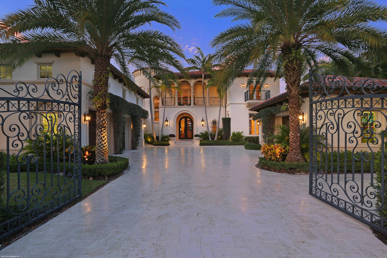 From the moment you arrive through the private gate, this custom home built in 2011 home will captivate you. Relaxed sophistication & casual elegance is found in this five-bedroom, six and two-half bath custom waterfront estate home, situated on a very desirable lot surrounded by the golf course and beautiful water. The elegant two-story foyer flows to the first floor living areas that include the formal living room with a fireplace and formal dining room featuring a glassed-in wine room. The designer kitchen is state-of-the-art, coffered ceilings, two islands & breakfast nook. The kitchen area is open to the family room and provides access to the pool and lanai area. The first floor has a large master suite with an elegant master bath, deep soaking tub, dual sinks, and custom boutique style closets. One additional bedroom suite is also on the first floor along with an office. If you like to entertain, this home makes it easy. Enjoy countless hours outside with the elegant lanai with summer kitchen, a bocce ball court, and resort styled pool. The entire residence is luxuriously appointed and thoughtfully designed with attention to every detail. A four and a half car garage completes the estate.