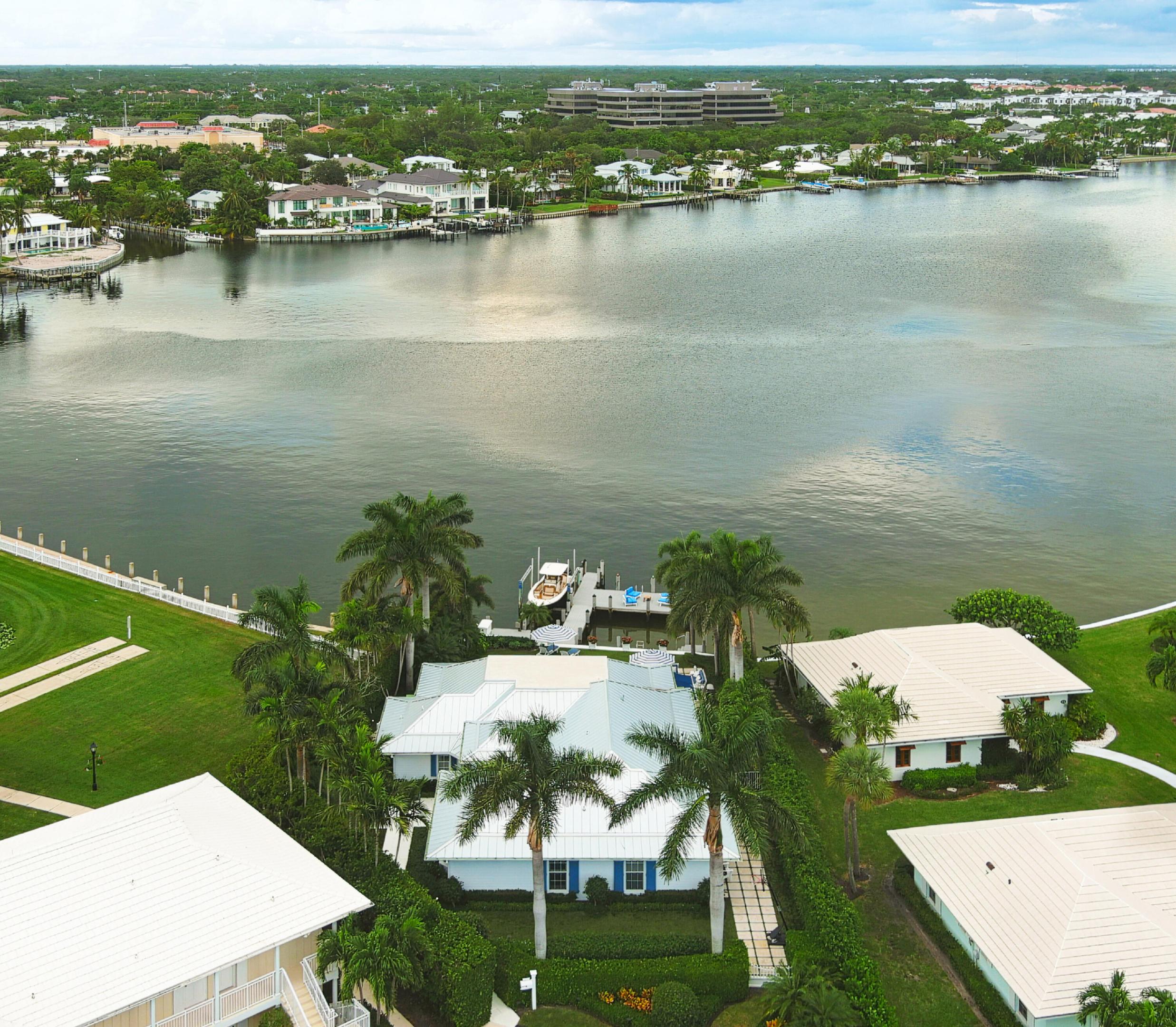 Spectacular Waterviews! Access to the Ocean. Completely renovated featuring 4 bedrooms, 4.5 baths, vaulted ceilings, wood floors, top of the line appliances, pool, electric screens and boat dock! Professionally decorated and the furnishings stay with the residence. Don't miss seeing this conveniently located home within walking distance to the golf club, spa, and beach club!