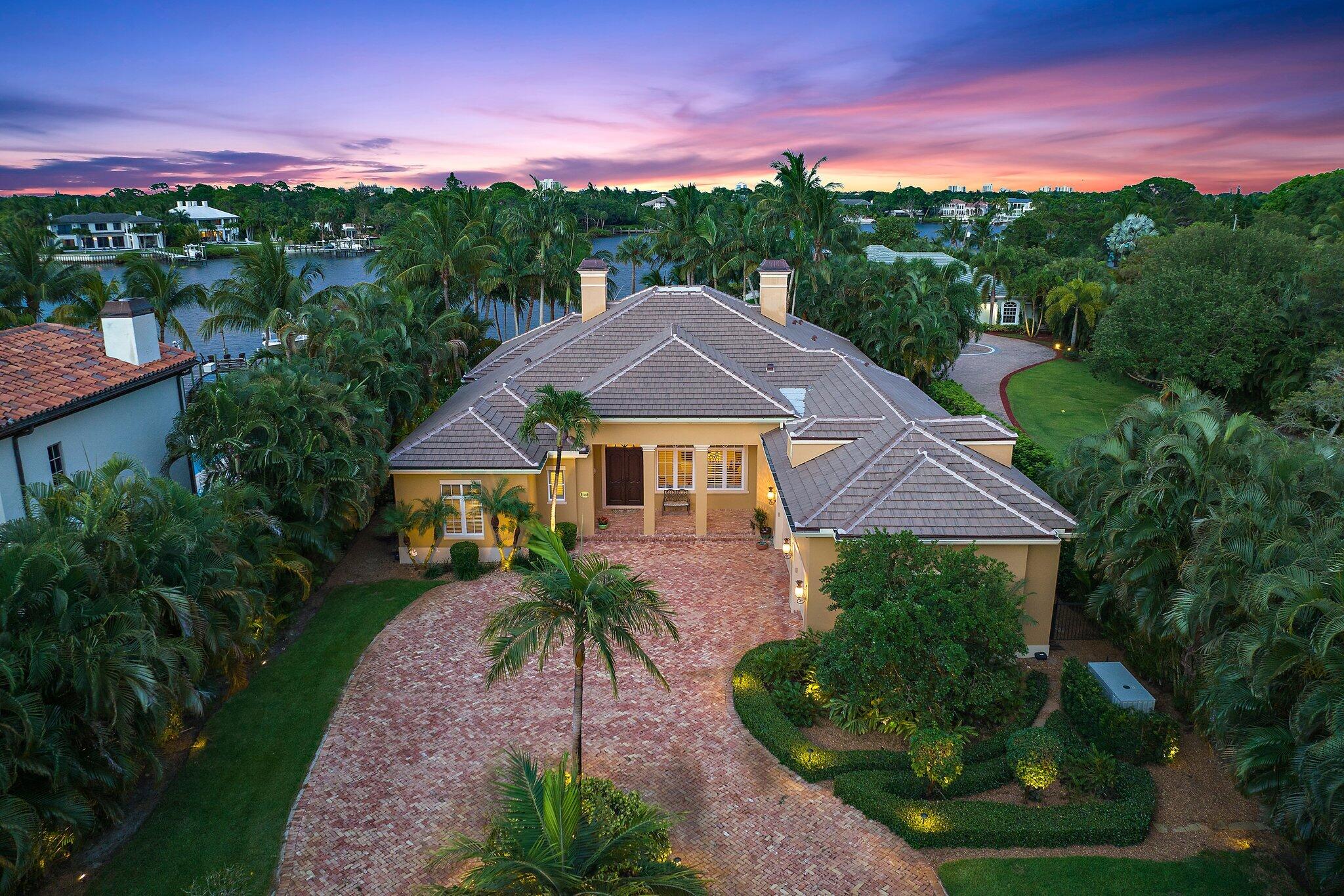 Immaculate 5BR/5Bth/3-car garage riverfront estate on the wild and scenic Loxahatchee River with lush tropical landscaping. This magnificent 1 acre estate was built in 2004 on the site of the historic Young Family Pineapple Plantation. Enter through the custom double door entry & grand foyer into the formal living room with fireplace, wet-bar and French Doors leading to the patio/pool area. The spacious and elegant dining room with adjacent butler's pantry sits just off the gourmet kitchen with prep-island, custom cabinetry and top of the line stainless steel appliances. The kitchen overlooks the spacious family room and breakfast area which offers breathtaking views of the patio, pool, backyard & river. Luxury abounds in the large Master Suite with sitting area and two large walk-in closets with built-ins. The master bathroom is an oasis of pleasure with his and her vanities, private water closet with bidet, large walk-in shower and separate roman tub. The large home theatre room with a 10' projection screen is ideal for relaxing and taking in a good movie or TV show with family and friends. This tropical paradise has a heated pool w/ spa and features a dock on the river with 13,000lb boat lift and plenty of dock space for friends visiting by water. Minutes from the Jupiter Inlet, this spectacular home is a boaters paradise with two private beaches and a kayak launching area.