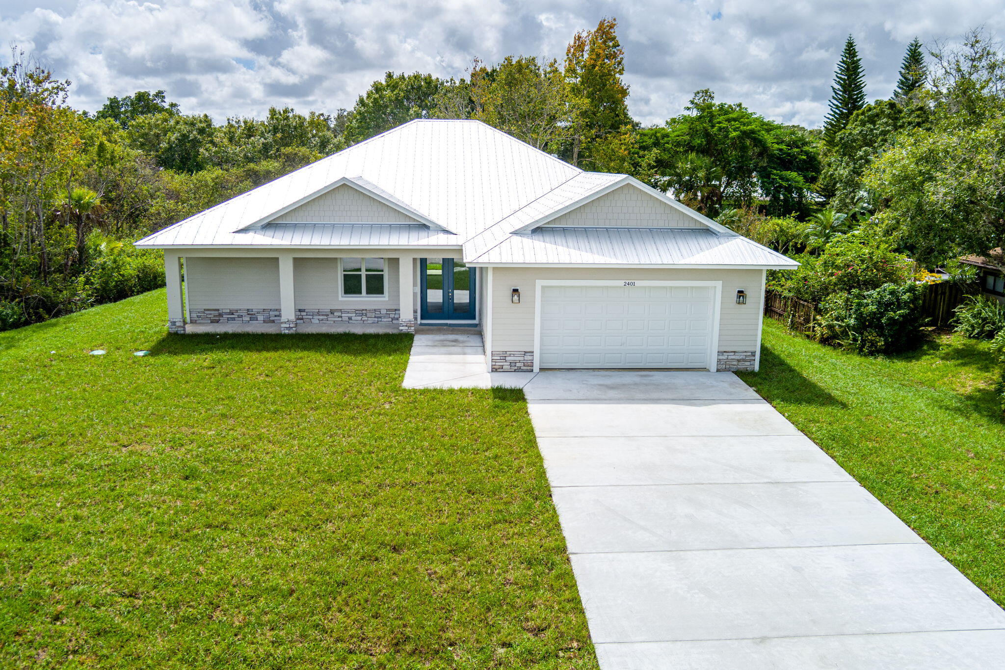 NEW CONSTRUCTION!! Nestled in this small quaint community, this 3 bedroom, 3 full bath home has plenty of room for entertaining. From the double glass front door entry to the summer kitchen on the oversized back porch, this home has it all. On this 1/2 acre lot with some preserve that was left for privacy, you will find this home is well equipped for energy efficiency with the impact windows and doors and a metal roof. Inside you will find tile throughout the entire home, large custom shower in the master bath plus two additional full baths as well as a large kitchen island and a double door pantry off the kitchen. Custom framed ceilings inside and tongue and groove porch ceilings just add to the beauty of this home.