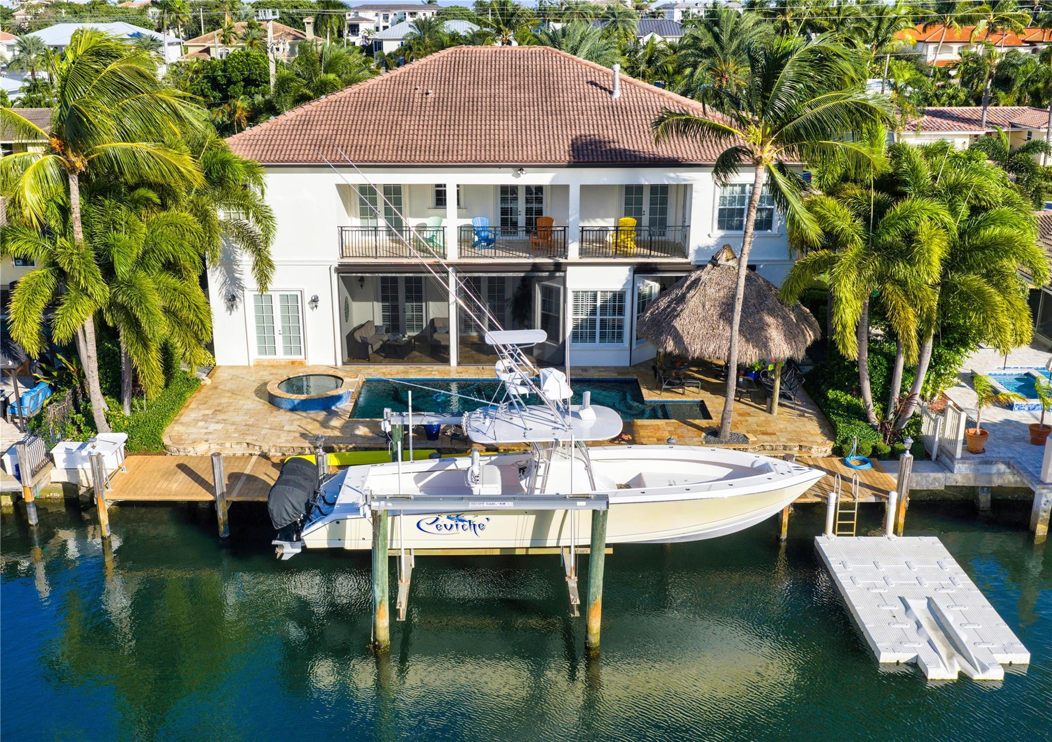 Exceptional Mediterranean deepwater estate sited on 80’ of waterfrontage, offering 6 bedrooms, 6.1 baths and 5,546± SqFt of refined living. Light-filled interiors feature a flexible floorplan with both upper- and lower-level living, including a second-level primary suite with private sitting area, fireplace and expansive waterfront balcony. The custom kitchen showcases quartzite countertops, Wolf gas cooktop, custom cabinetry, and is complemented by a waterfront breakfast nook and wet bar. Additional features include impact windows and doors, new paint, elevator, and 3-bay garage. Outdoor living is enjoyed on a marble-pavered patio with covered loggias, refinished heated pool with spill-over spa, custom tiki hut, and a 70’ composite yacht dock just minutes to the Hillsboro Inlet. DISCLAIMER: Information published or otherwise provided by the listing company and its representatives including but not limited to prices, measurements, square footages, lot sizes, calculations, statistics, and videos are deemed reliable but are not guaranteed and are subject to errors, omissions or changes without notice. All such information should be independently verified by any prospective purchaser or seller. Parties should perform their own due diligence to verify such information prior to a sale or listing. Listing company expressly disclaims any warranty or representation regarding such information. Prices published are either list price, sold price, and/or last asking price. The listing company participates in the Multiple Listing Service and IDX. The properties published as listed and sold are not necessarily exclusive to listing company and may be listed or have sold with other members of the Multiple Listing Service. Transactions where listing company represented both buyers and sellers are calculated as two sales. “No payments made until title passes” Some affiliations may not be applicable to certain geographic areas. If your property is currently listed with another broker, please disregard any solicitation for services. Information published or otherwise provided by seller, listing company or its representatives is deemed reliable but are not guaranteed and subject to errors, omissions, or changes without notice. Copyright 2026 by the listing company. All Rights Reserved.