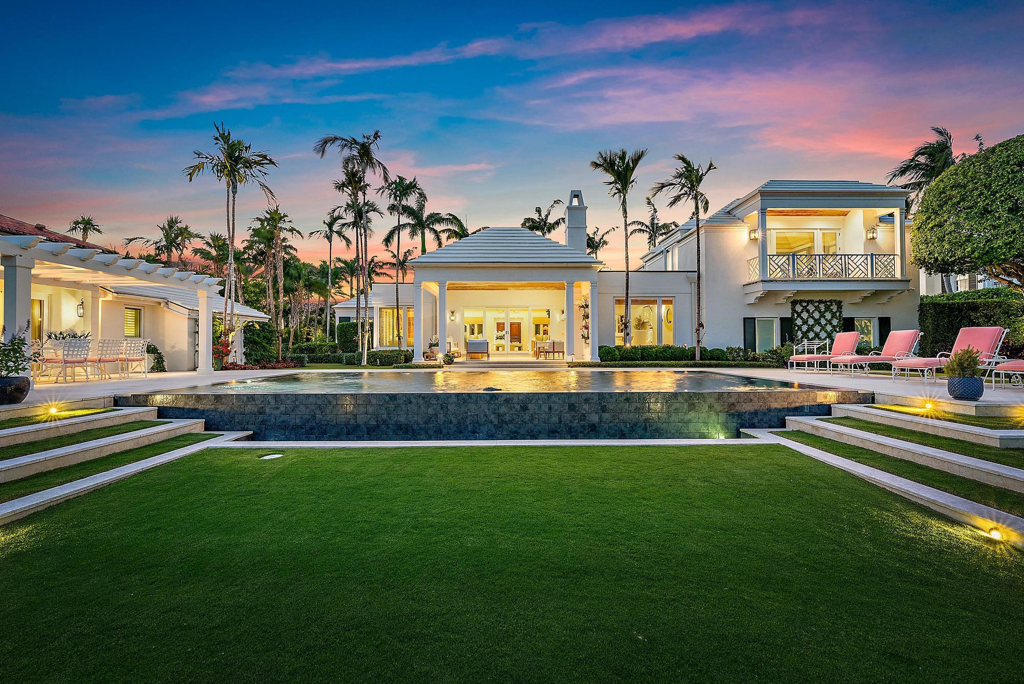 BEAUTIFULLY REIMAGINED: This Bermuda gem evokes an island lifestyle and ambiance which is ideal for families and entertaining. The interior has been beautifully reimagined and is now in total harmony with the tropical gardens that surround the house. The home is the epitome of ''Palm Beach Chic'' in the truest sense. Architectural elements include soaring pickled wood ceilings throughout the house, outdoor covered loggias with a fireplace and an infinity pool which all create a magical setting overlooking 150' of water frontage. There is a separate pool house positioned alongside the water which consists of a large living room with vaulted ceilings, bedroom, bathroom, morning bar and outdoor gazebo for ''alfresco'' dining. The house was taken down to the studs in 2016 and SEE MORE: completely rebuilt with no expense spared. The renovation includes a cement slurry roof, all impact windows and doors, a new seawall, boat lift, 2 floating docks and a full house generator just to name a few. The outdoor lighting is exquisite throughout the garden and illuminates the water at night from the seawall. The effect is stunning. This is island living at its best.