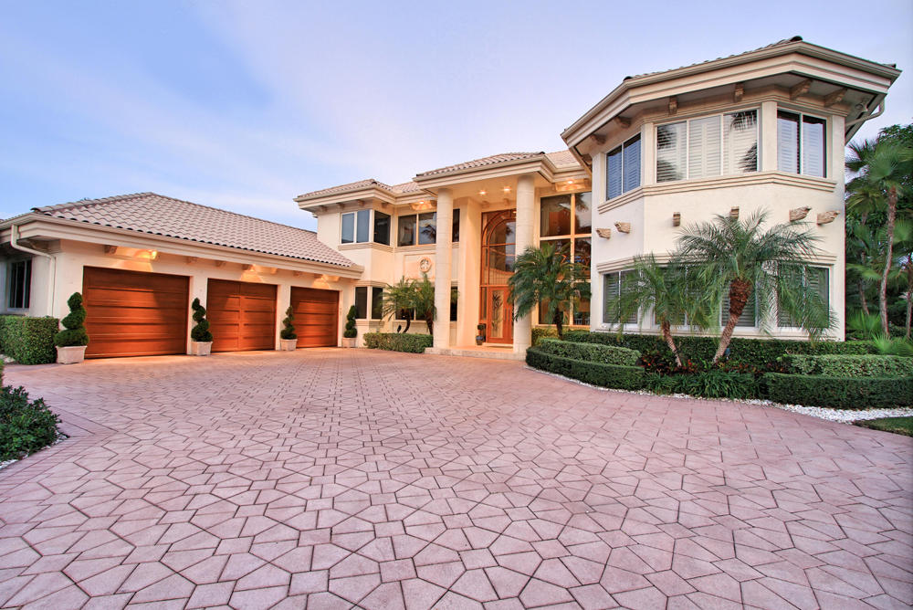 Waterfront residence in Royal Palm Yacht & Country Club with quick access to the Intracoastal and ocean inlet. Completely remodeled in 2008, this home has five bedrooms, four full and two half bathrooms, formal living and dining rooms, gourmet kitchen with custom wood cabinetry and granite countertops, opening to breakfast area and family room with fireplace and bar. Great place for entertaining, this home has a gathering room, wine room and movie theater. Second floor master suite has his and her closets, large master bathroom, and balcony with views overlooking the waterway. Other features include an elevator, private pool and patio area with spa tub, fully equipped dock, lush tropical landscaping, and impact glass windows and doors (front door is not impact glass).