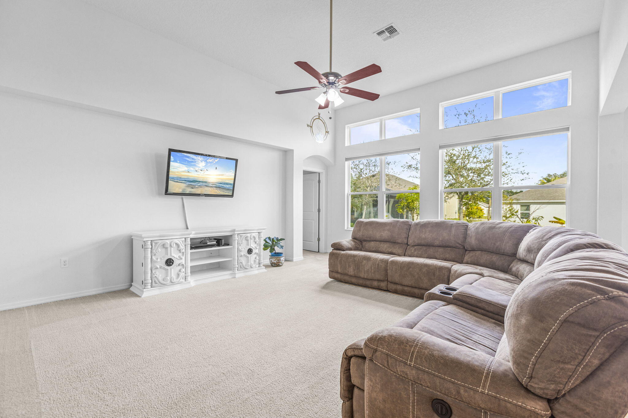 Spacious, bright, and designed for today's family living. This newer-build home offers 9-12 ft ceilings, abundant natural light, and a desirable split floorplan. Featuring 4 bedrooms, 3 baths, plus a flex room with a closet—perfect for a home office, playroom, or 5th bedroom. A private wing includes a bedroom and full bath, offering ideal separation for guests or multigenerational living. Enjoy a large kitchen with granite, SS appliances, and an island giving an open concept layout. This home has freshly painted interiors, an oversized 2 car garage (4ft more), wider driveway fits many cars & toys (RV Boat), and a generous backyard. Solar panels keep the power bill around $45/month. Close to shopping and dining options in St. Lucie West. Short drive to Fort Pierce beach. Ideal location!