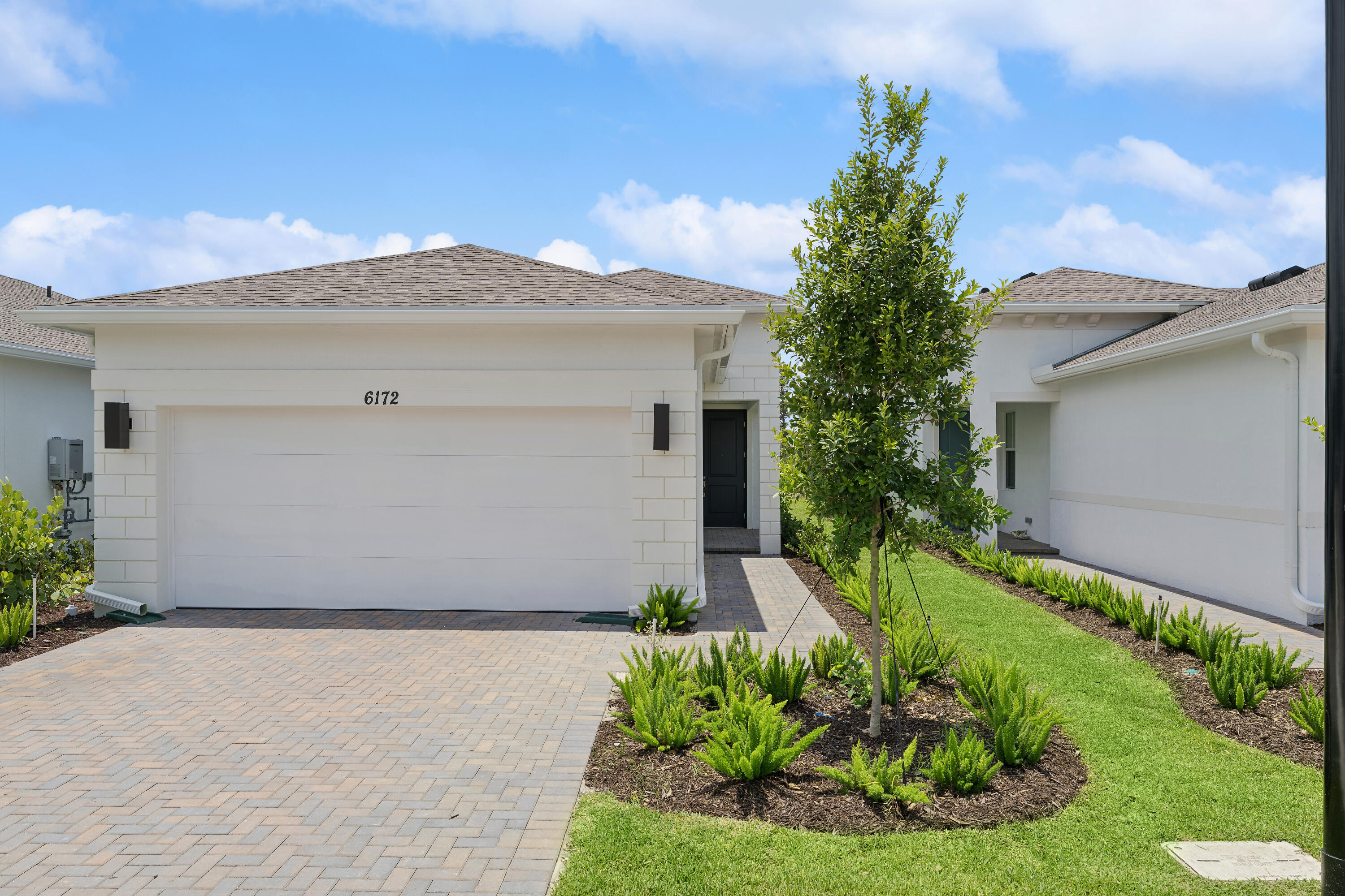 Check out this beautifully designed Spring Lake IV villa, ideally situated on a quiet cul-de-sac with both preserve and water views in a 55+ community. Showcasing our designer-curated Classic Look, this thoughtfully designed home features an open-concept layout that blends comfort and style. The stunning kitchen offers elegant white double-stacked cabinetry with soft-close drawers, floating shelves, a sprawling island, and Statuary Classique quartz countertops. The adjacent dining area and spacious great room create an inviting space for everyday living and entertaining, while the covered patio extends your living space outdoors. The bright primary suite features triple windows and tile flooring, creating a relaxing retreat.  A private home office provides the perfect space for work or hobbies. Designed for low-maintenance living, the Spring Lake IV is an exceptional villa that combines timeless finishes with a beautiful natural setting.