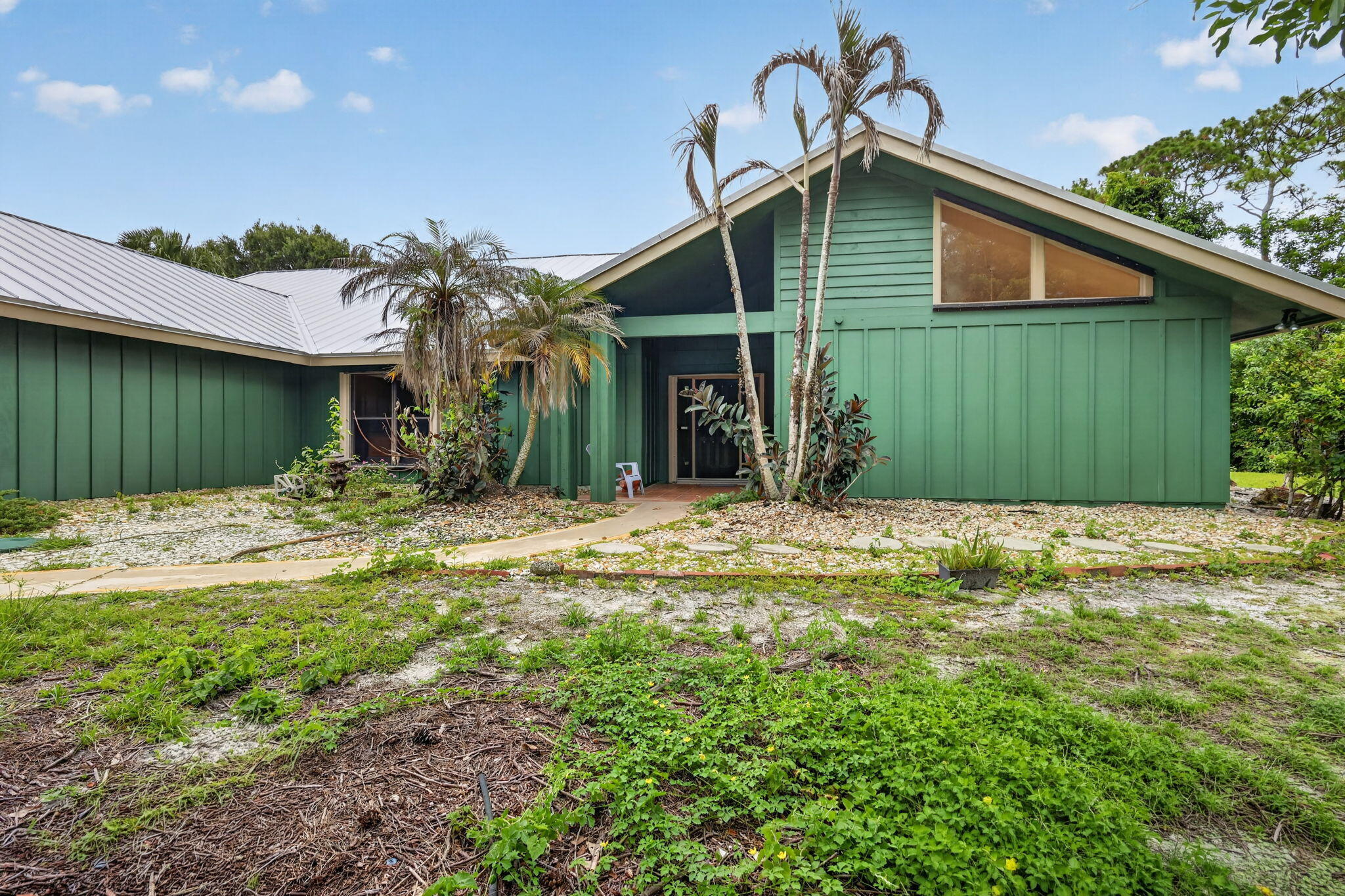Tucked inside Crane Creek Racquet Club in beautiful Palm City, this spacious three-bedroom, three-and-a-half-bath home sits on over an acre and offers 2,944 square feet of finished living space. Inside, you'll find vaulted cedar ceilings, skylights, a fireplace, and a bright, open feel throughout. A fourth room offers the perfect option for a den, office, guest space, or flex room to fit your needs. Additional highlights include a 2022 roof, private pool, and a two-and-a-half-car garage. The generous lot provides space, privacy, and a peaceful outdoor setting, while the established Crane Creek community offers the neighborhood charm and low monthly HOA Palm City buyers love. Crane Creek is known for its custom homes, mature landscaping, nature preserves, and wide-open spaces. The community also offers a 24-hour manned security gate and a convenient location close to Florida's Turnpike, I-95, shopping, dining, and highly rated schools. Martin Downs Golf Club is nearby and open to the public, adding another local convenience for those who enjoy golf, dining, or recreation close to home.